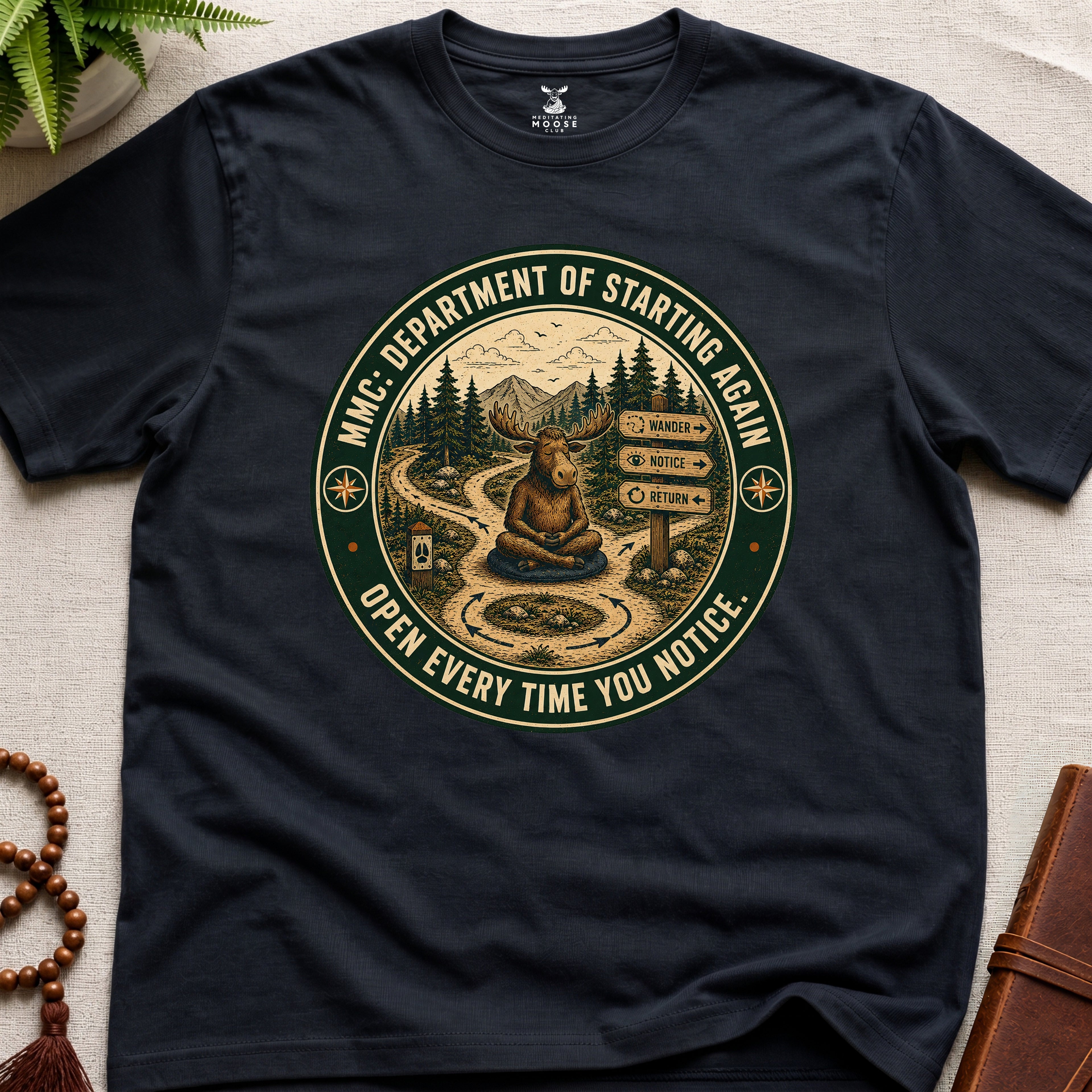 Black funny mindfulness t-shirt mockup featuring Meditating Moose Club Department of Starting Again moose graphic