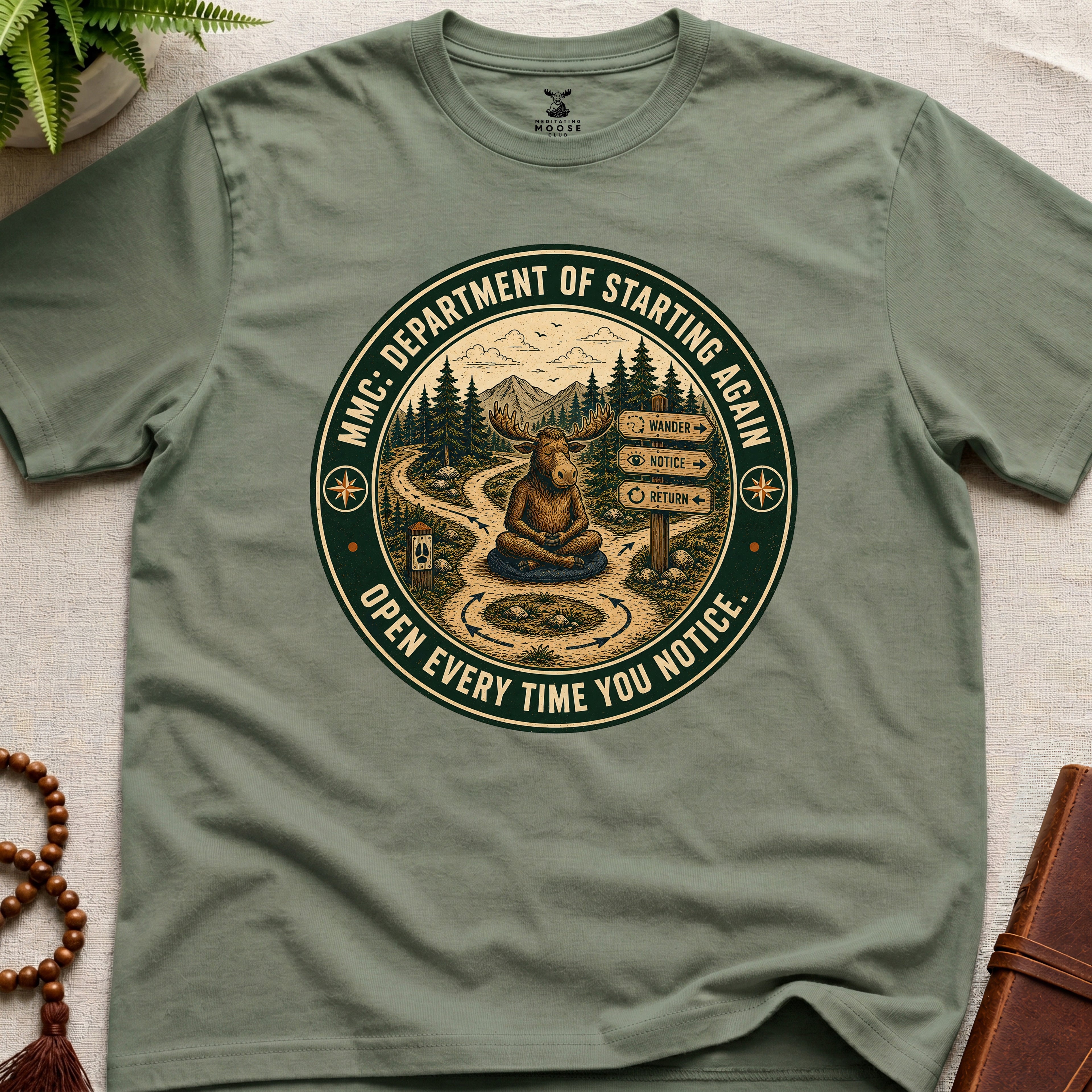 Green funny mindfulness t-shirt mockup featuring Meditating Moose Club Department of Starting Again moose graphic
