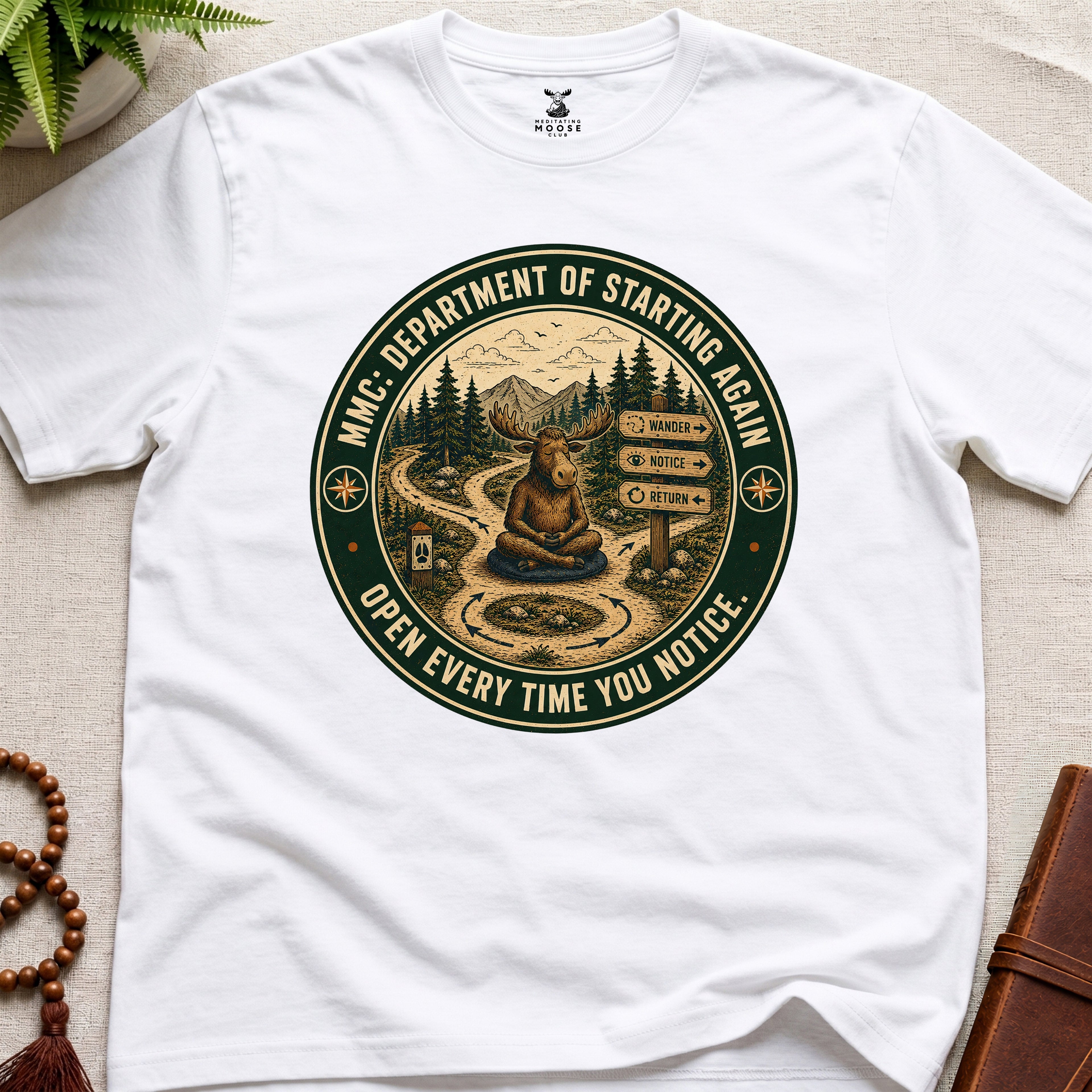 White funny mindfulness t-shirt mockup featuring Meditating Moose Club Department of Starting Again moose graphic