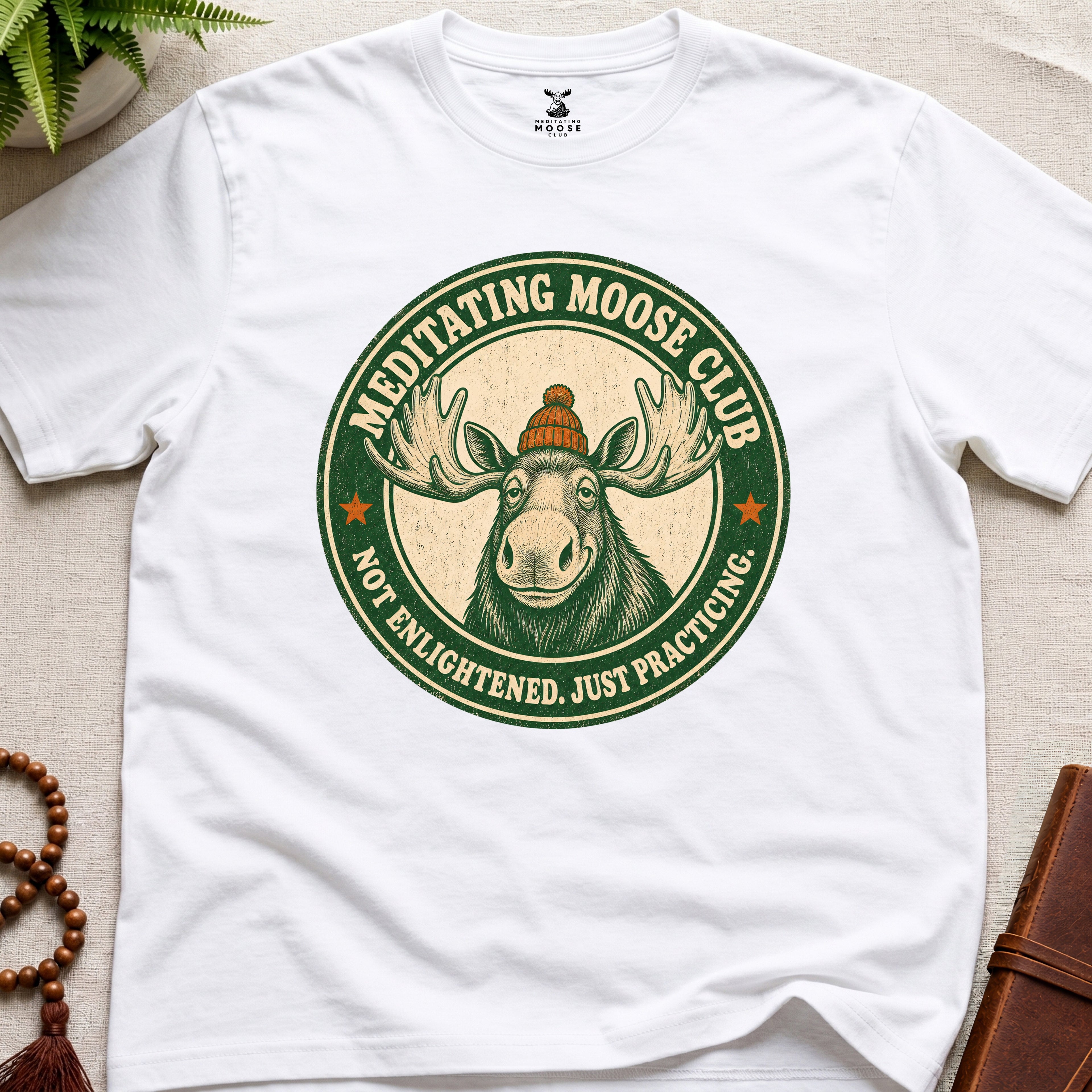 White mindfulness t-shirt mockup featuring Meditating Moose Club signature moose logo graphic