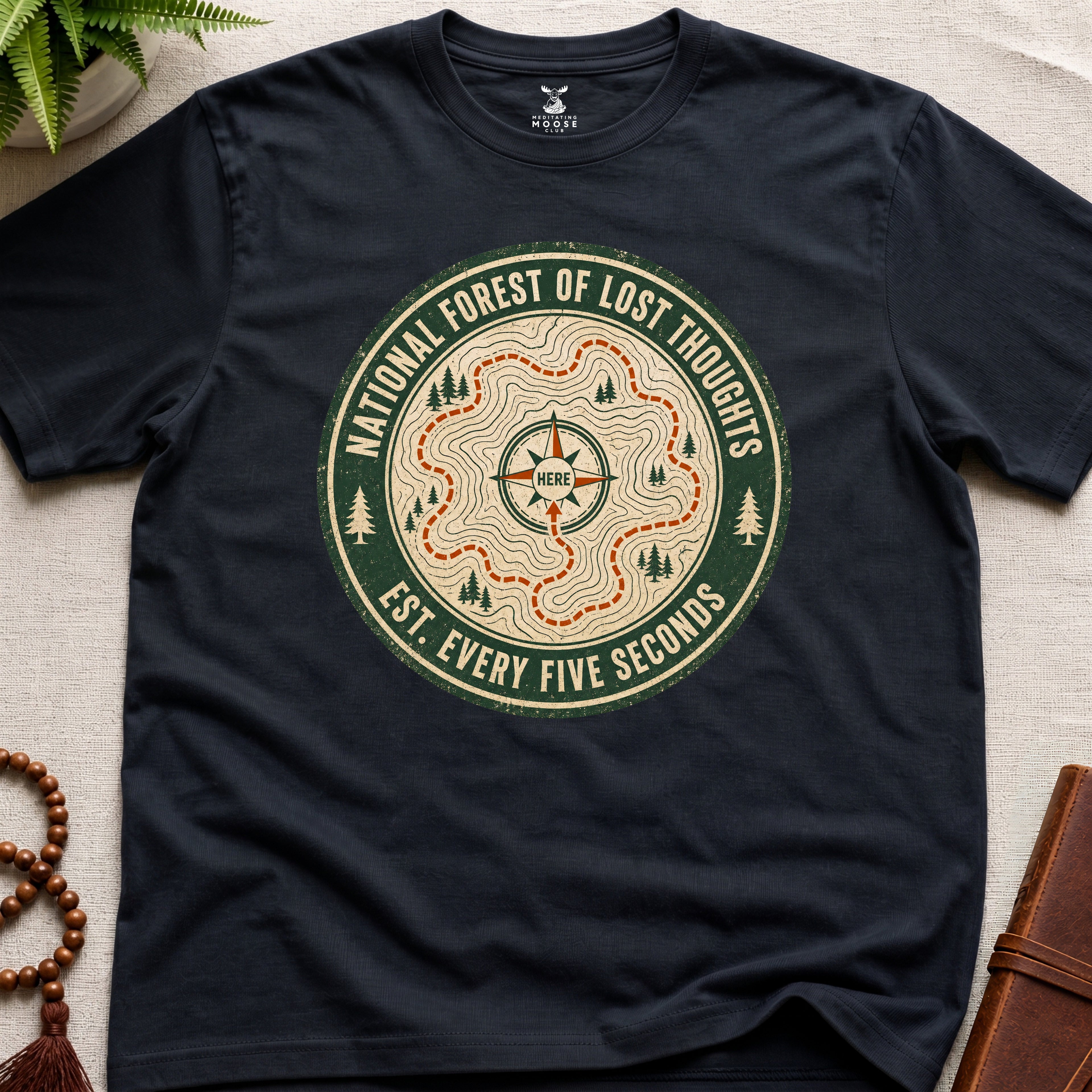 Black mindfulness t-shirt mockup featuring National Forest of Lost Thoughts vintage trail map meditation graphic