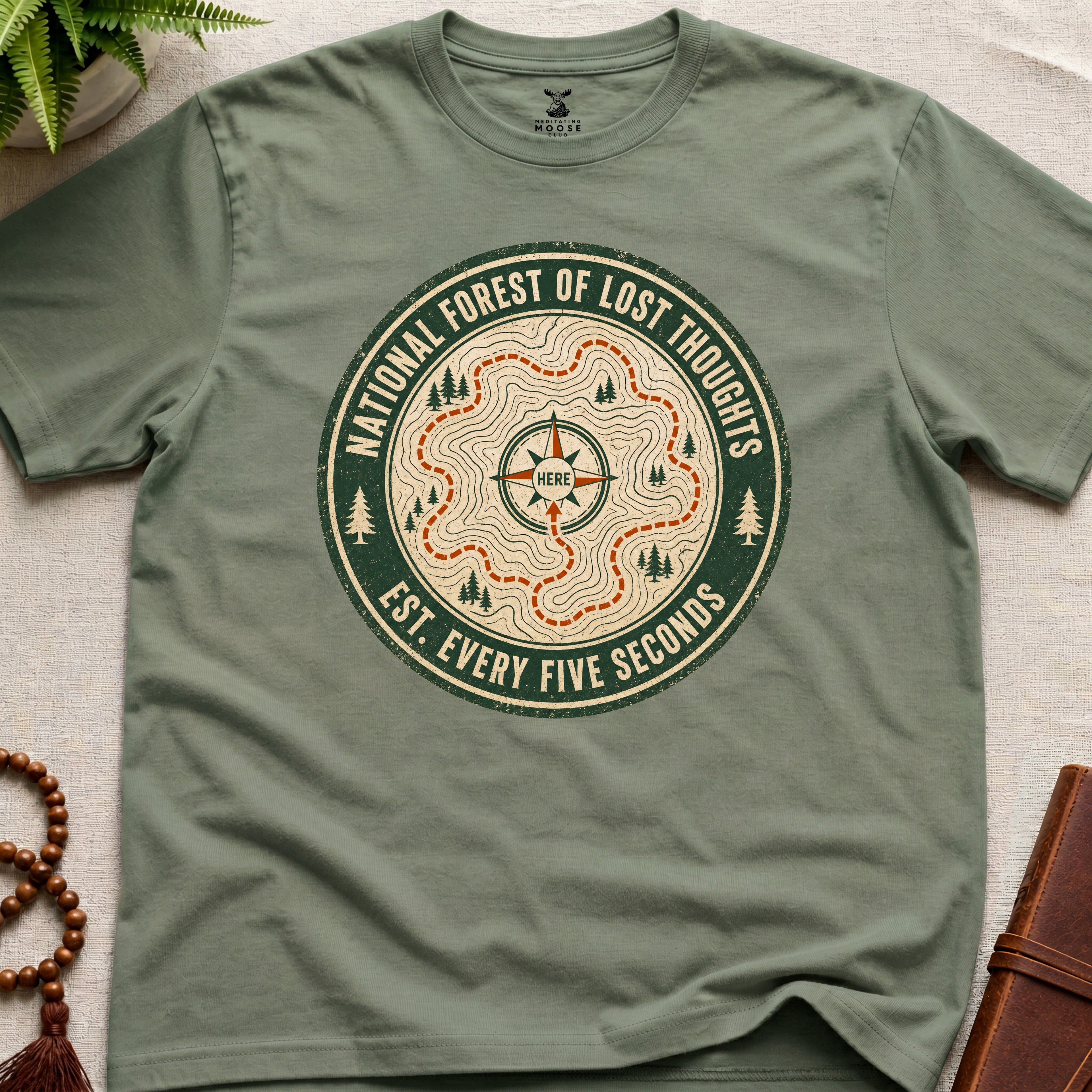 Green mindfulness t-shirt mockup featuring National Forest of Lost Thoughts vintage trail map meditation graphic