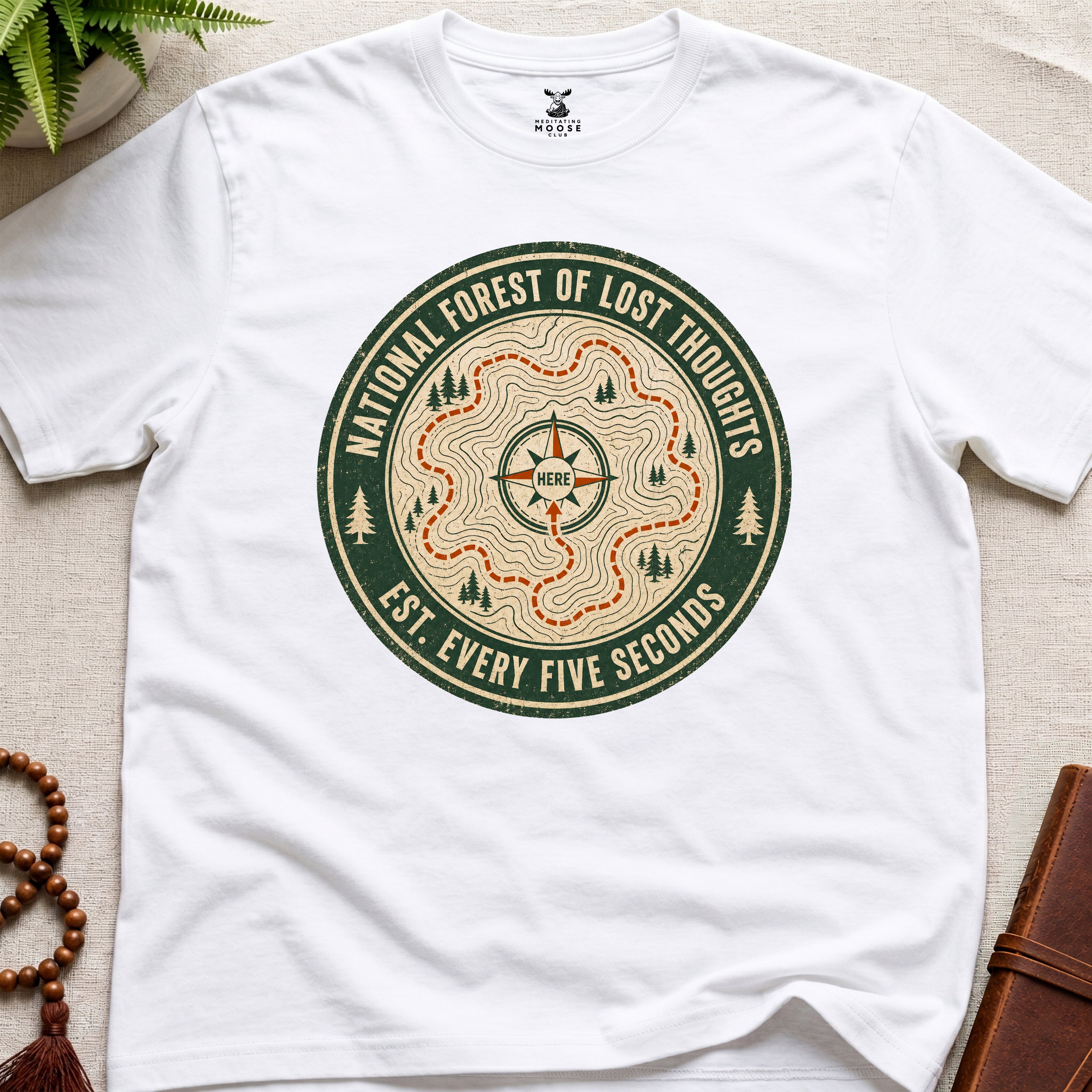 White mindfulness t-shirt mockup featuring National Forest of Lost Thoughts vintage trail map meditation graphic