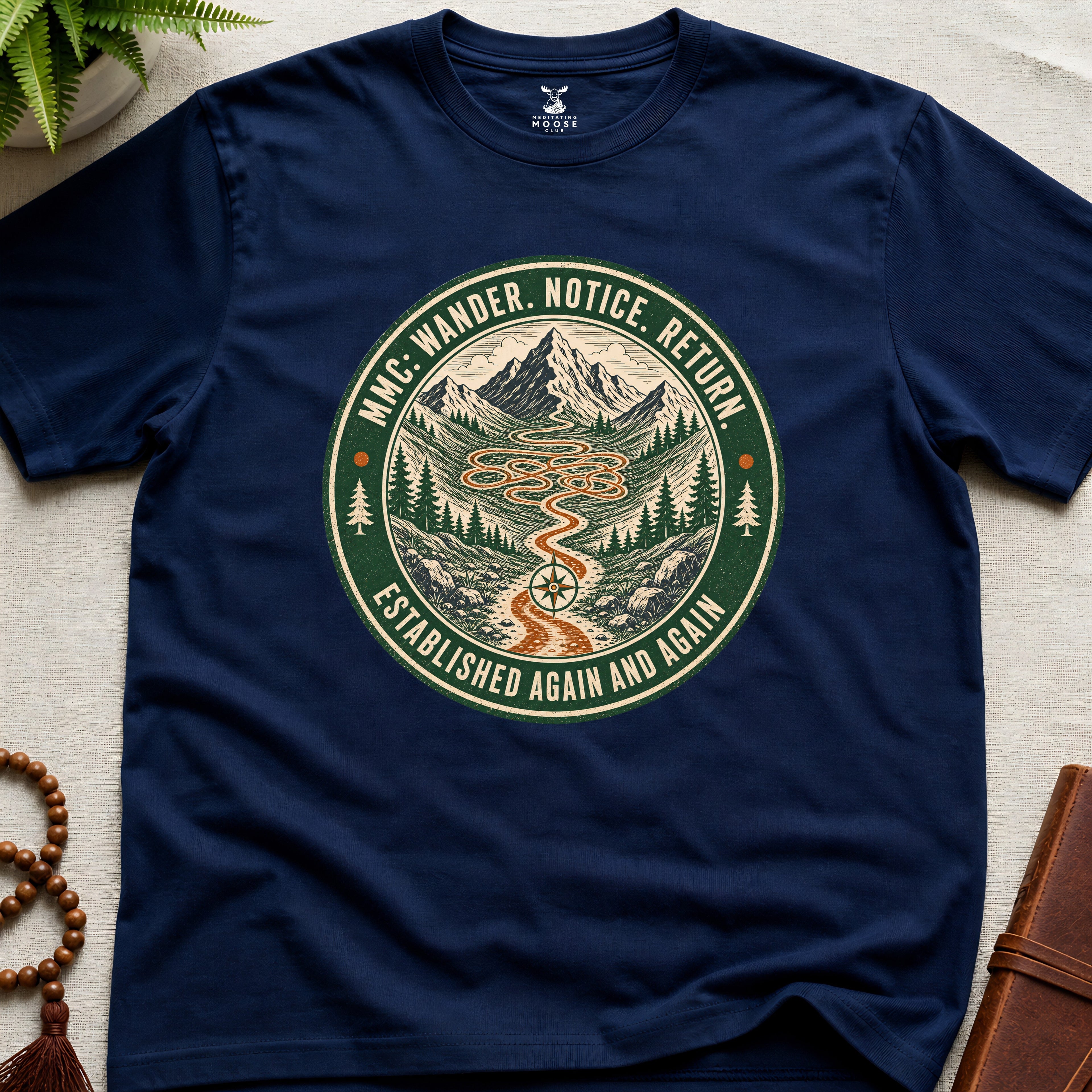 Navy mindfulness t-shirt mockup featuring Meditating Moose Club Wander Notice Return mountain trail badge graphic