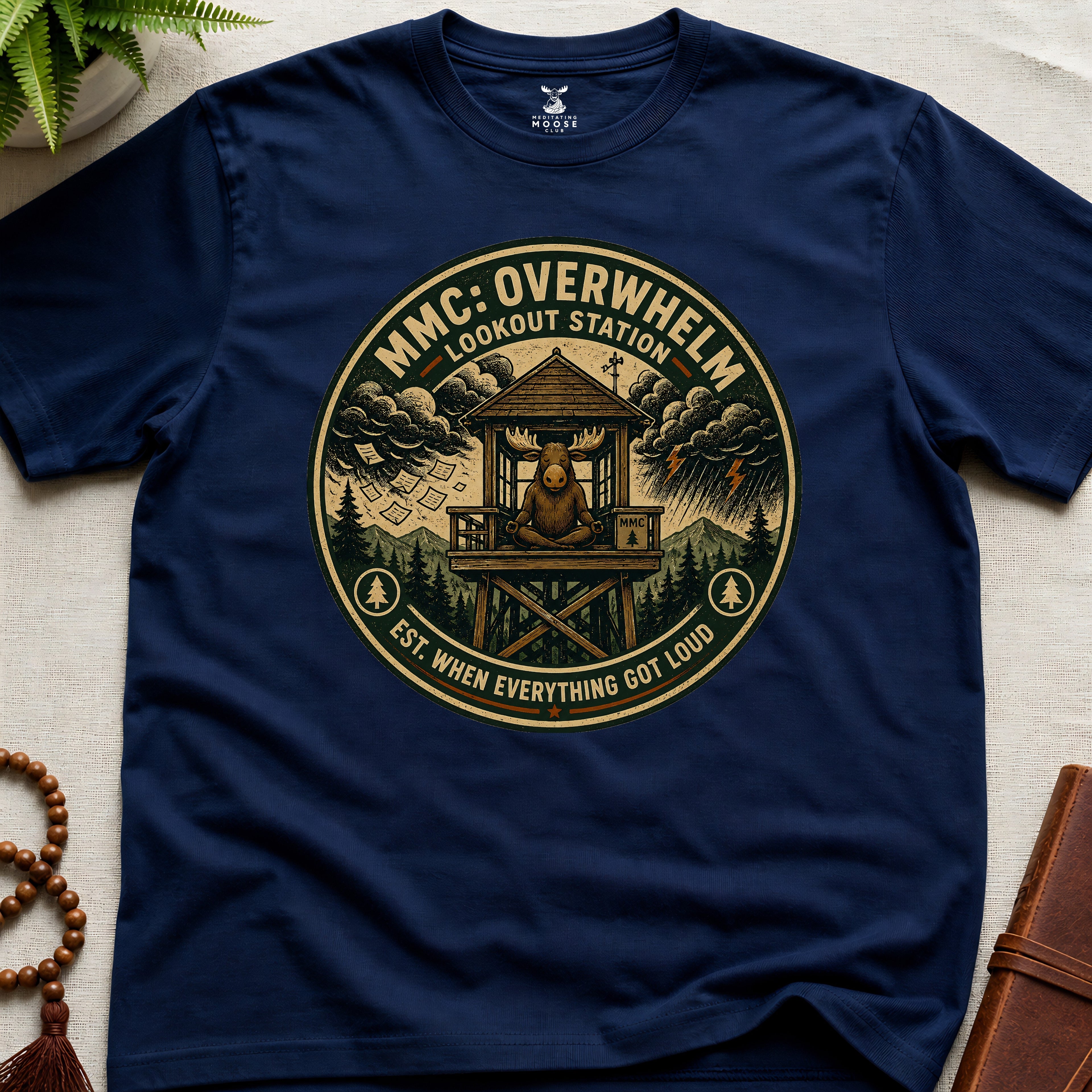 Navy mindfulness t-shirt mockup featuring Overwhelm Lookout Station meditating moose stress graphic