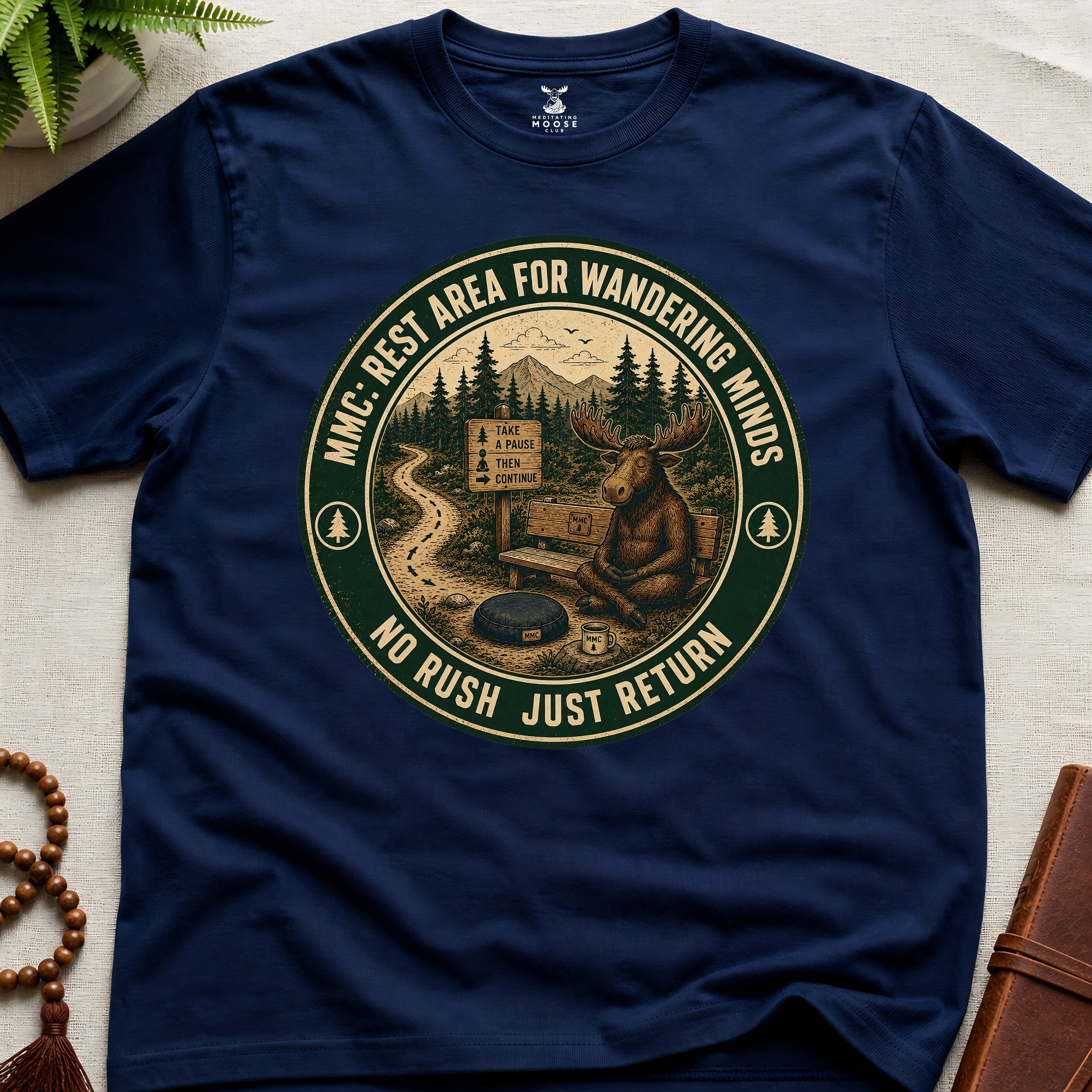Navy funny mindfulness t-shirt mockup featuring Rest Area for Wandering Minds meditating moose vintage badge design