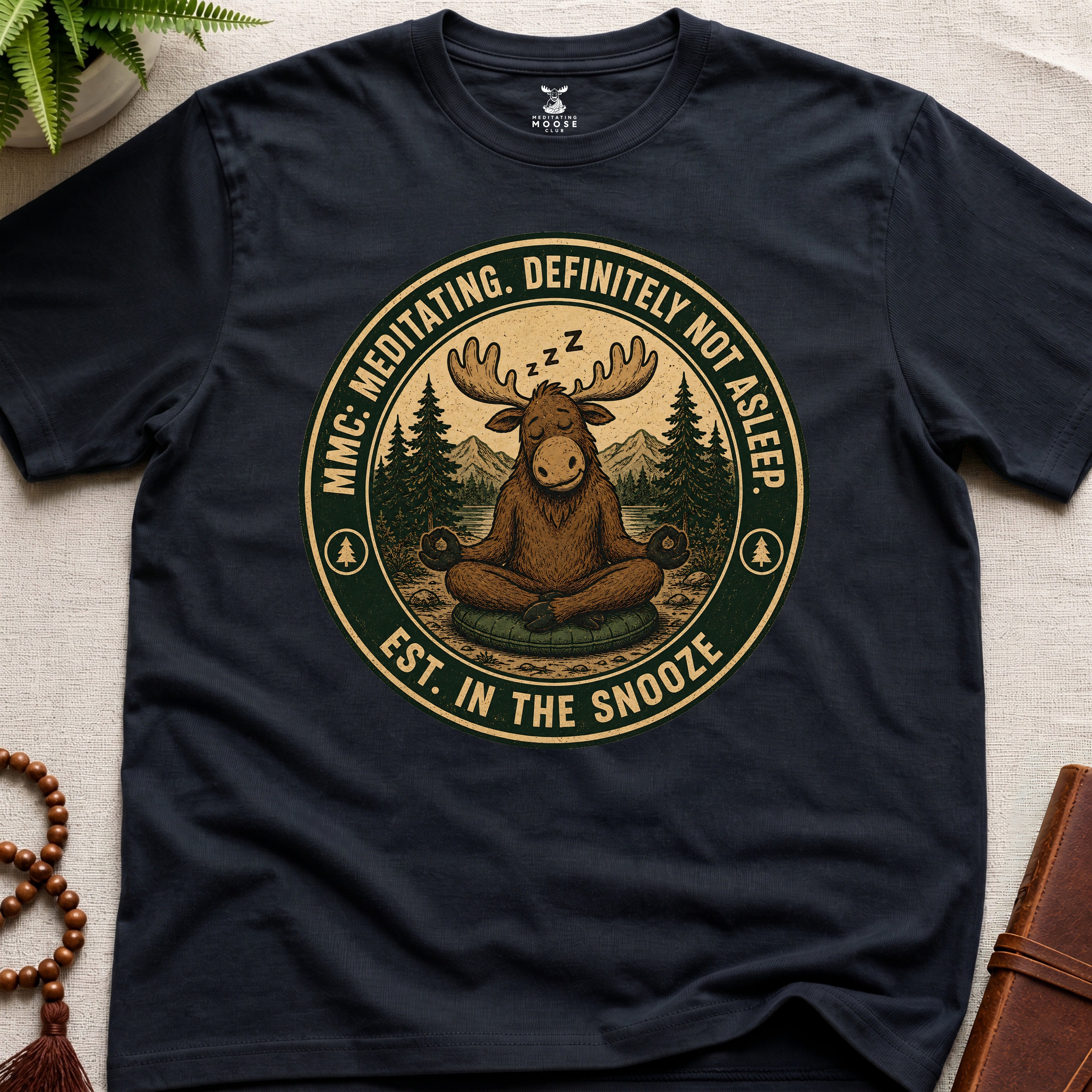 Black funny meditation t-shirt mockup featuring Meditating Moose Club sleepy moose mindfulness graphic