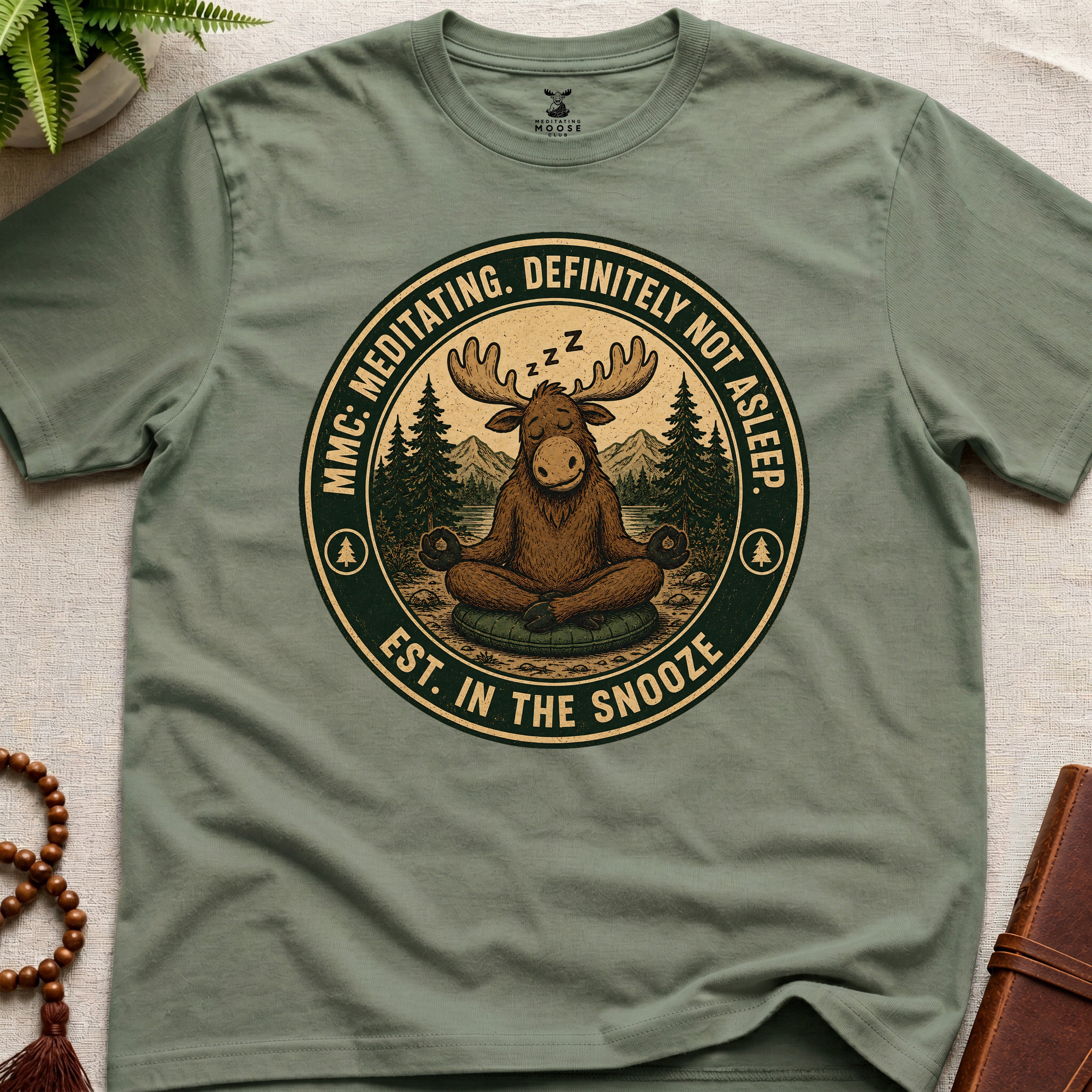 Green funny meditation t-shirt mockup featuring Meditating Moose Club sleepy moose mindfulness graphic