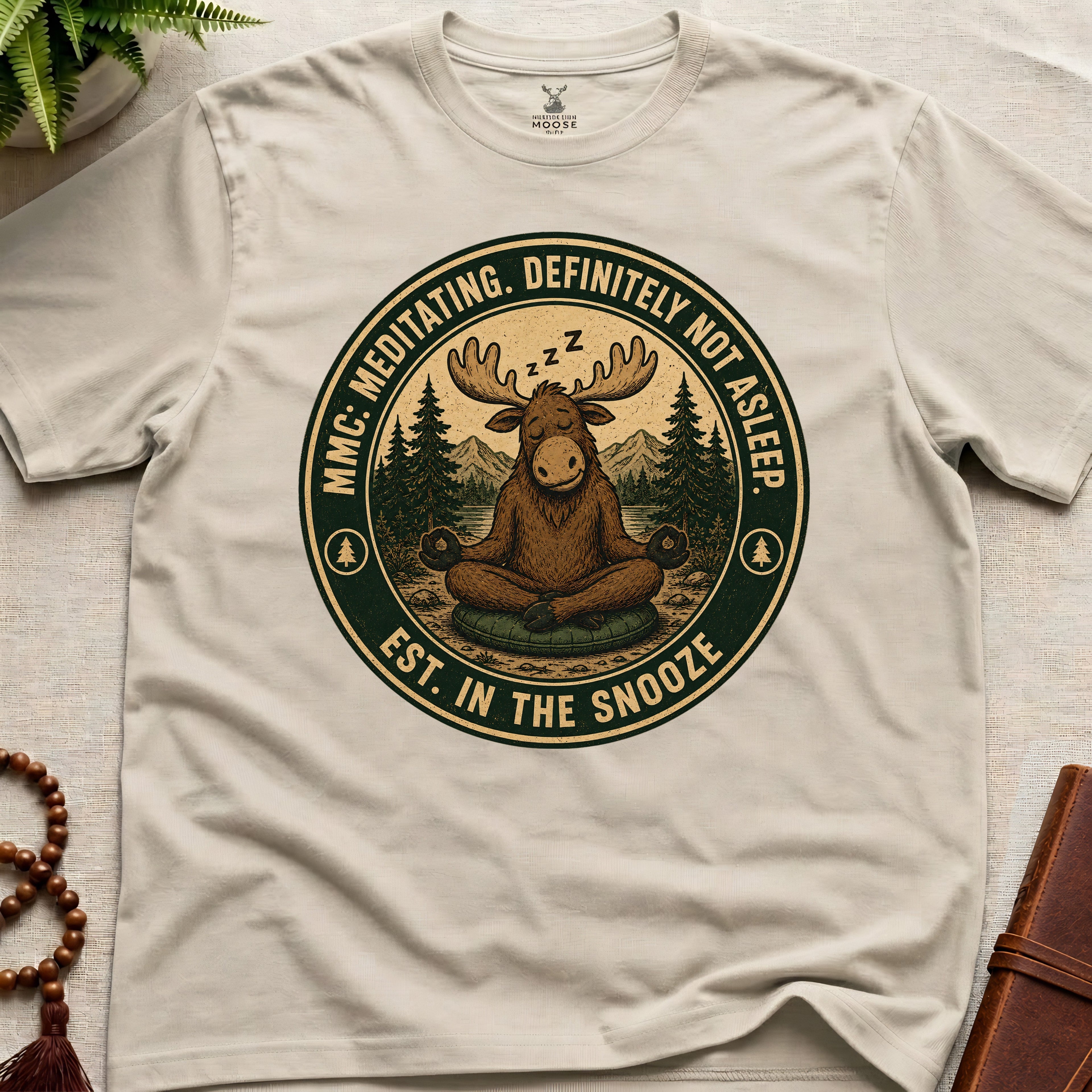 Beige funny meditation t-shirt mockup featuring Meditating Moose Club sleepy moose mindfulness graphic