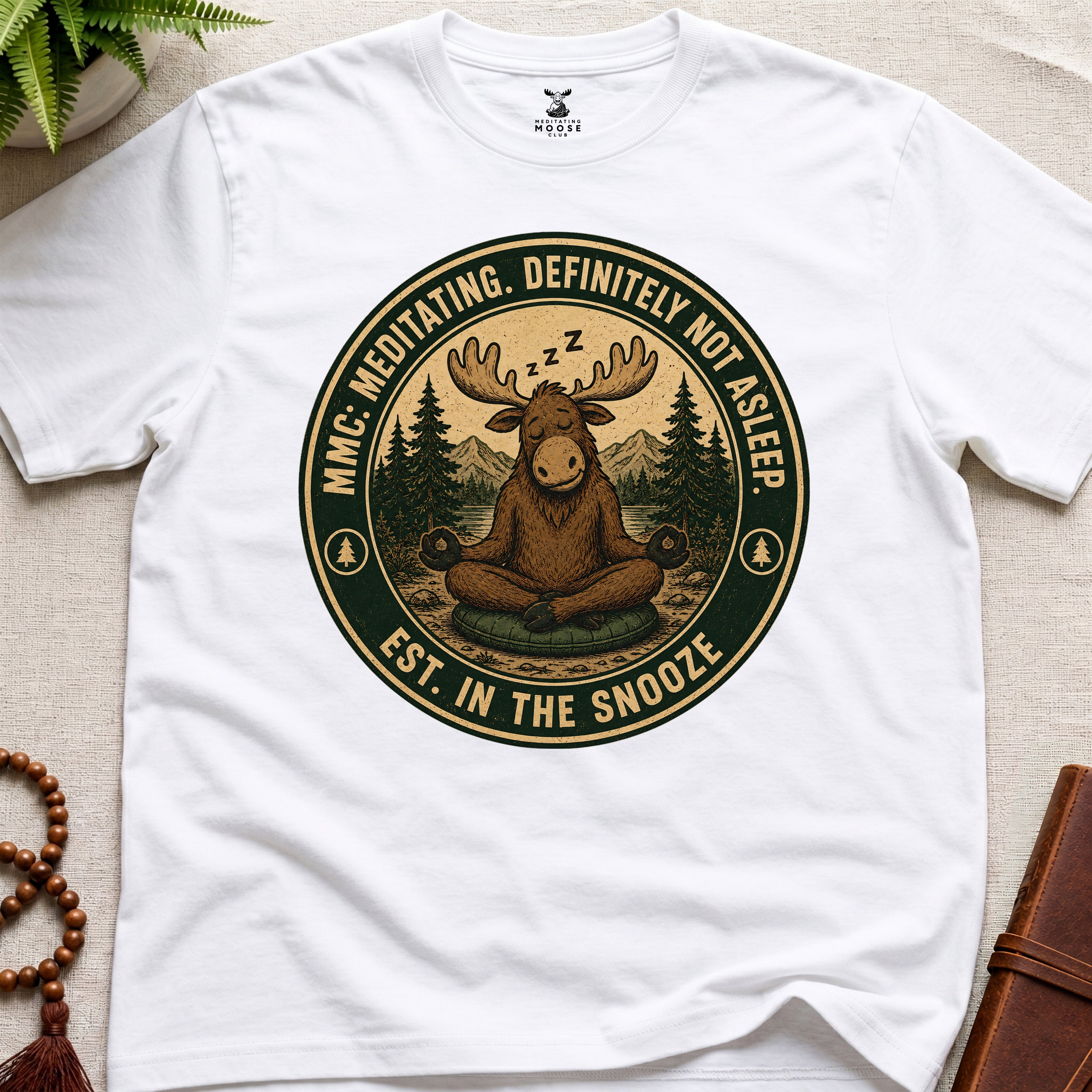 White funny meditation t-shirt mockup featuring Meditating Moose Club sleepy moose mindfulness graphic