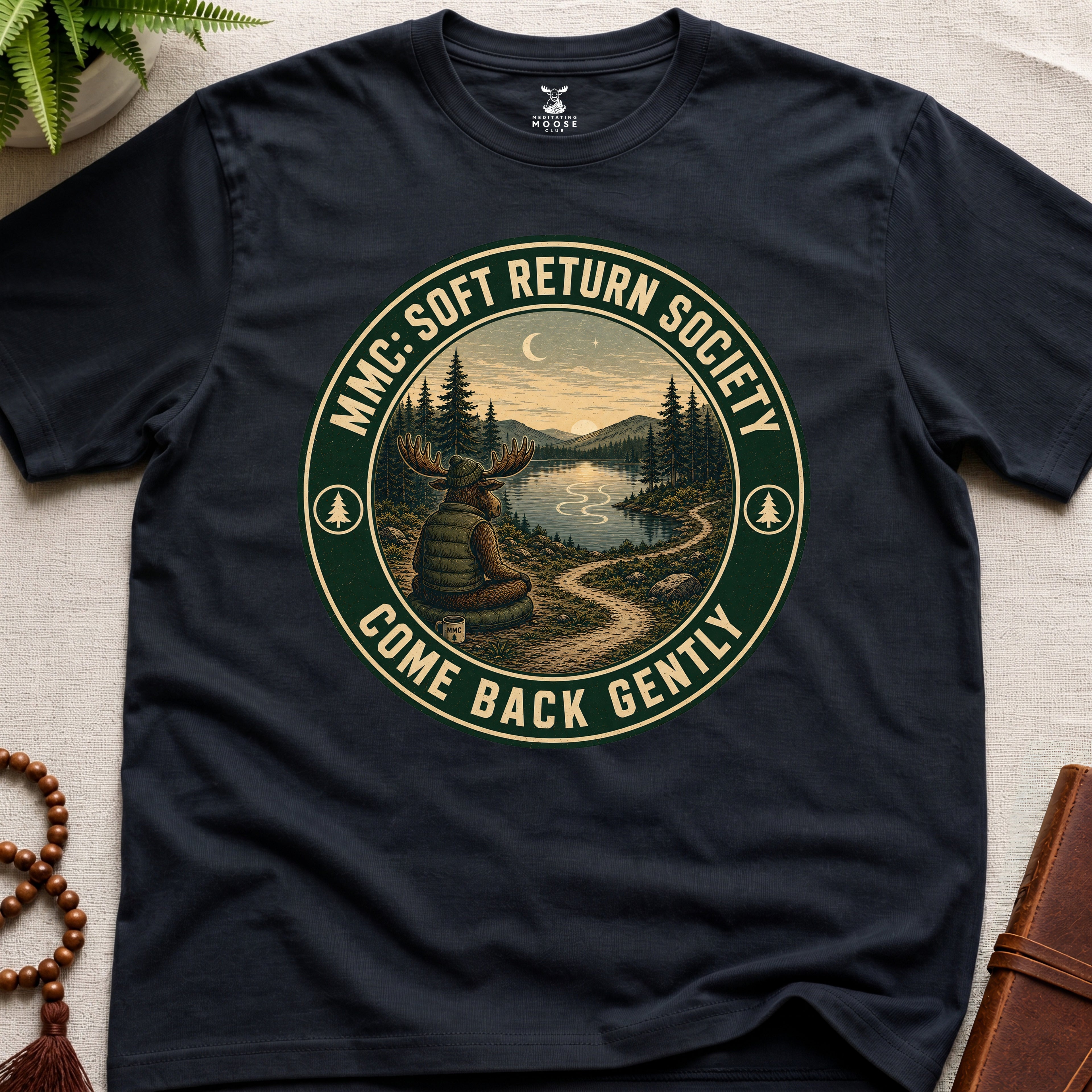Black mindfulness t-shirt mockup featuring Soft Return Society vintage wilderness meditation badge design