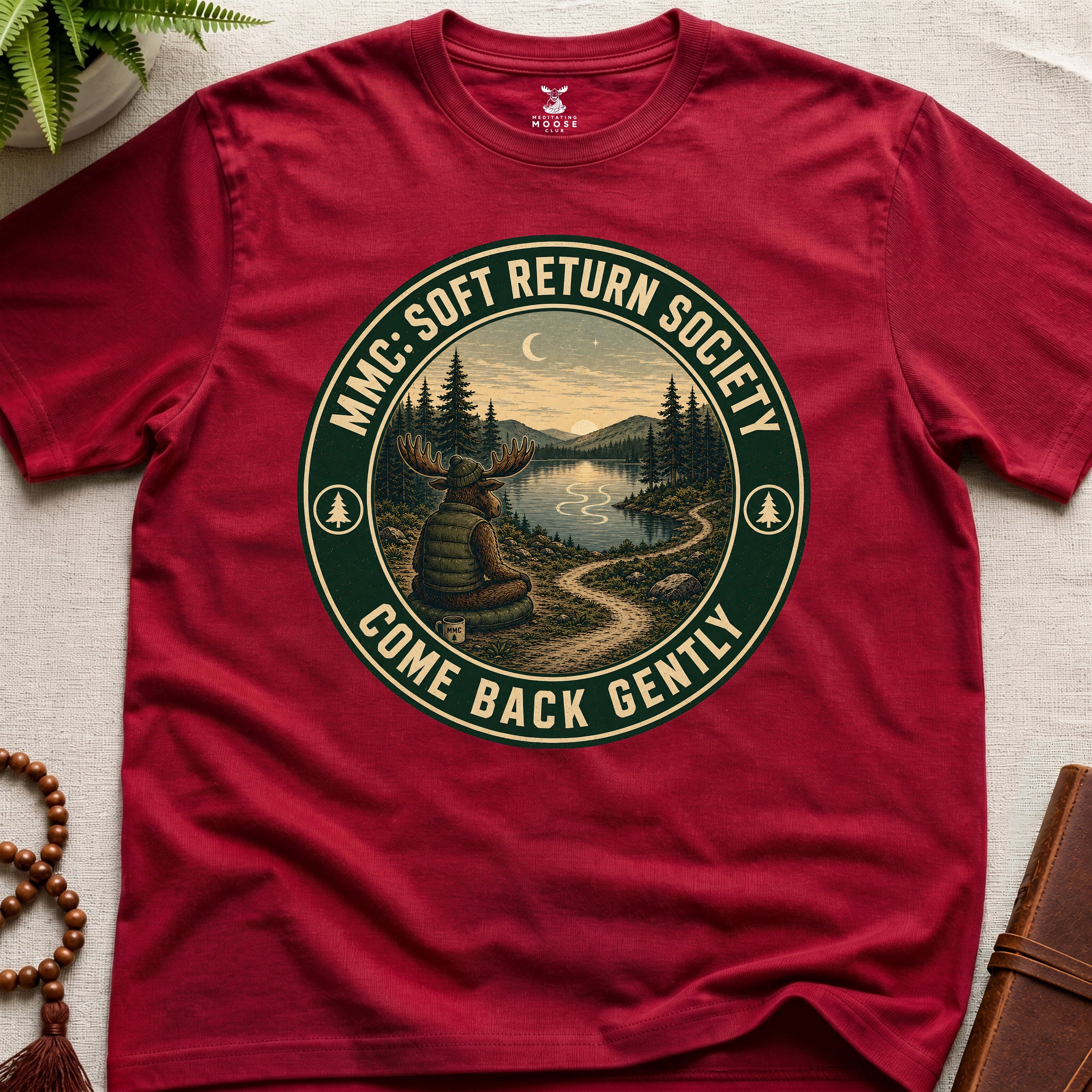 Red mindfulness t-shirt mockup featuring Soft Return Society vintage wilderness meditation badge design