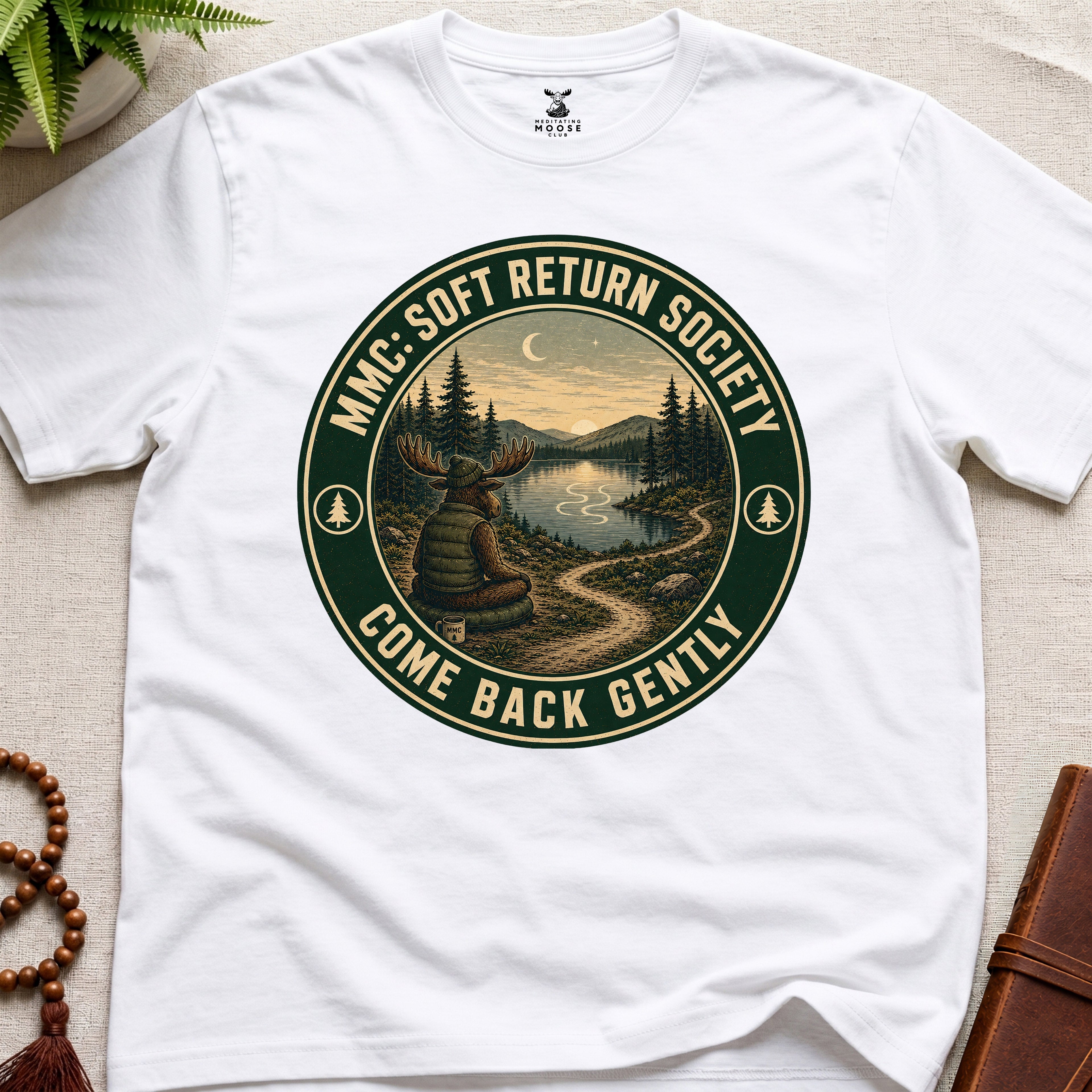 White mindfulness t-shirt mockup featuring Soft Return Society vintage wilderness meditation badge design