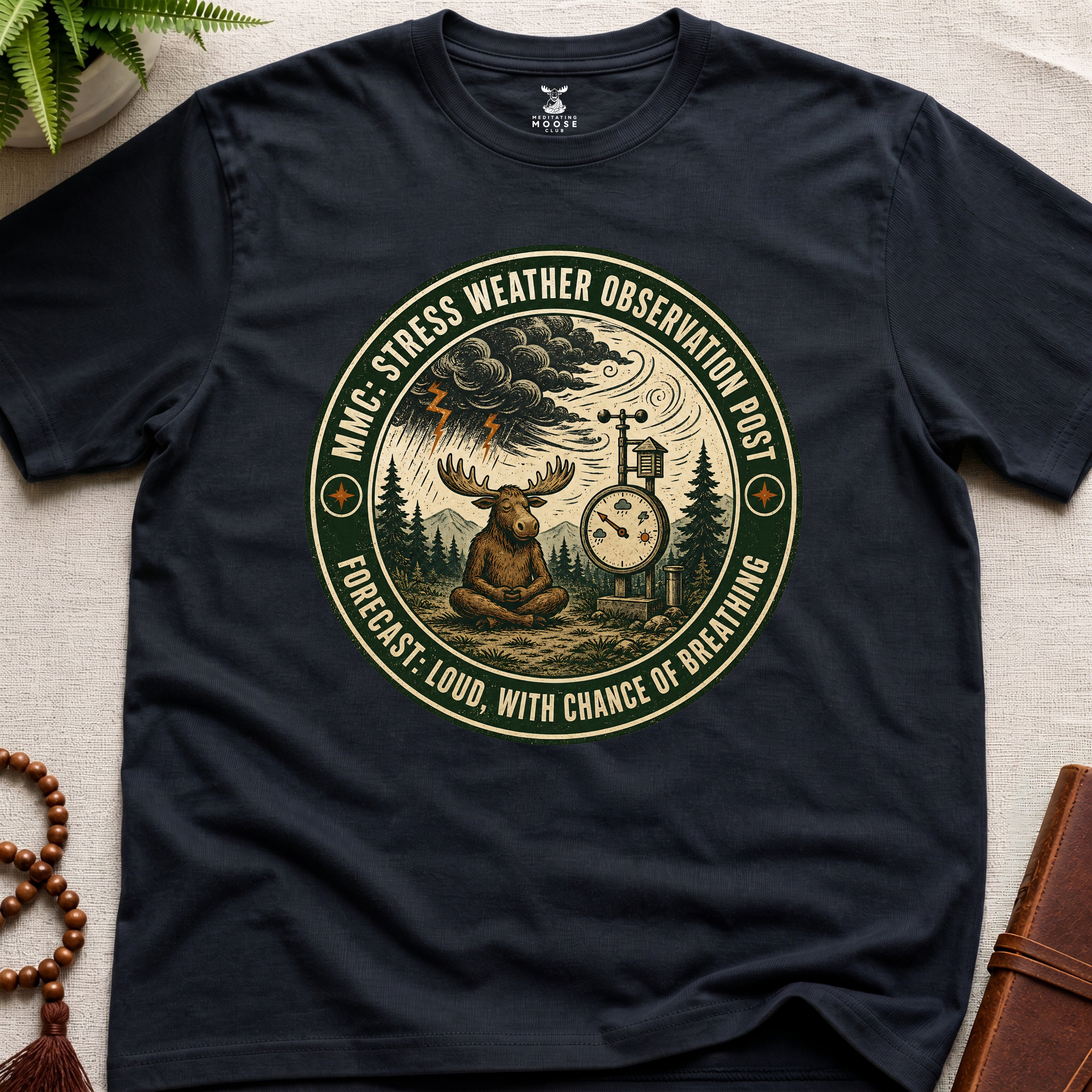 Black funny mindfulness t-shirt mockup featuring Stress Weather Observation Post meditating moose graphic