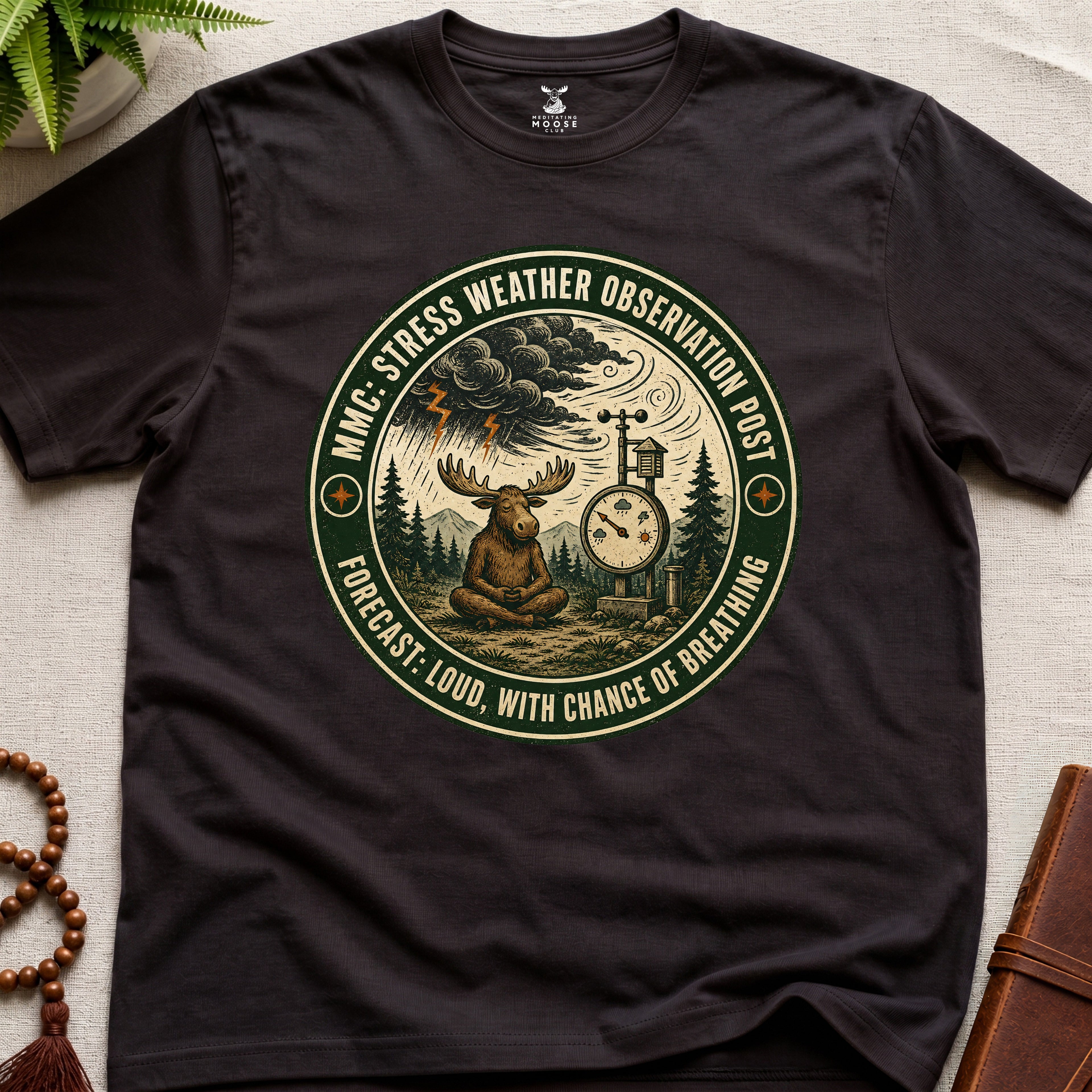 Dark brown funny mindfulness t-shirt mockup featuring Stress Weather Observation Post meditating moose graphic