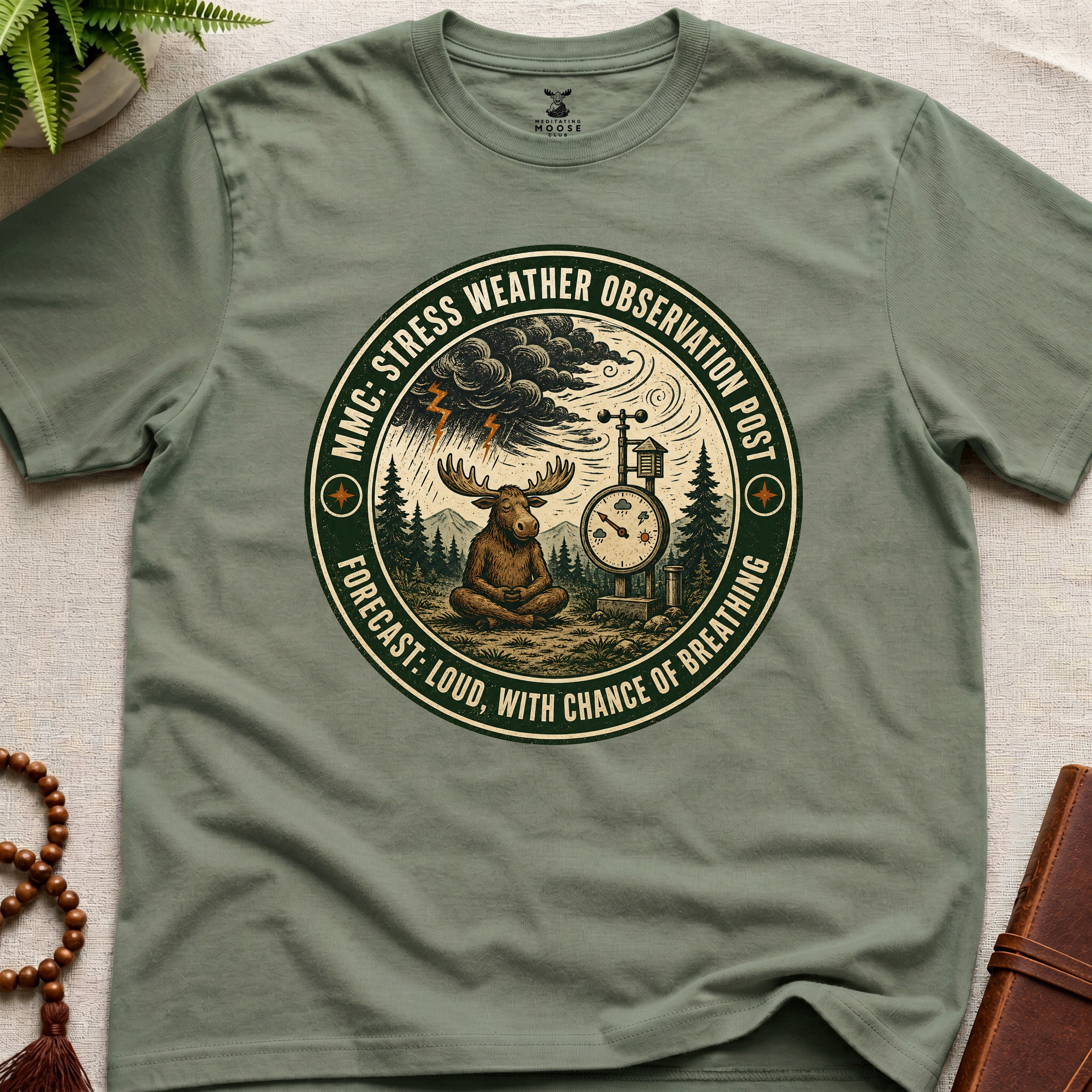 Green funny mindfulness t-shirt mockup featuring Stress Weather Observation Post meditating moose graphic
