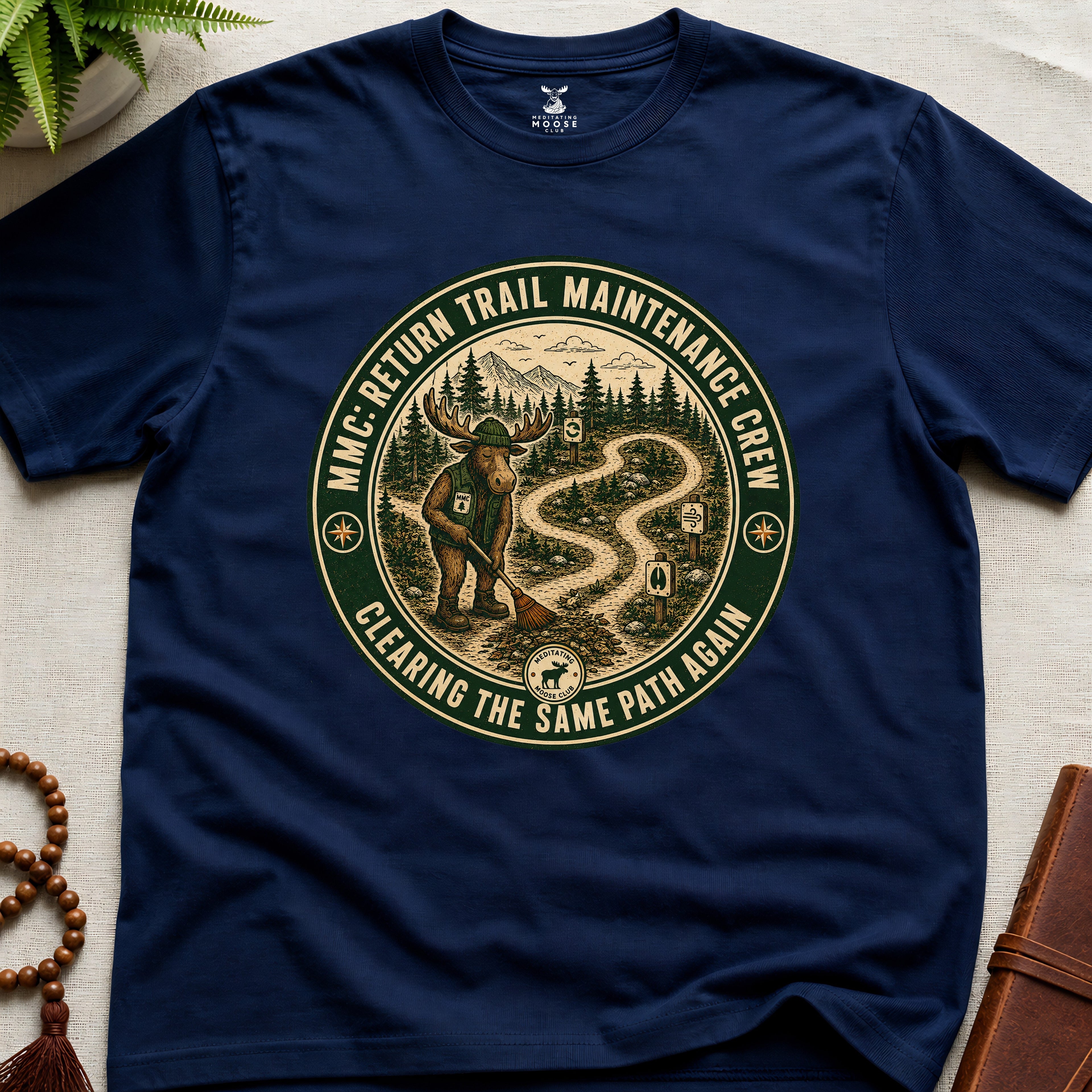 Navy mindfulness t-shirt mockup featuring Return Trail Maintenance Crew meditating moose vintage badge graphic