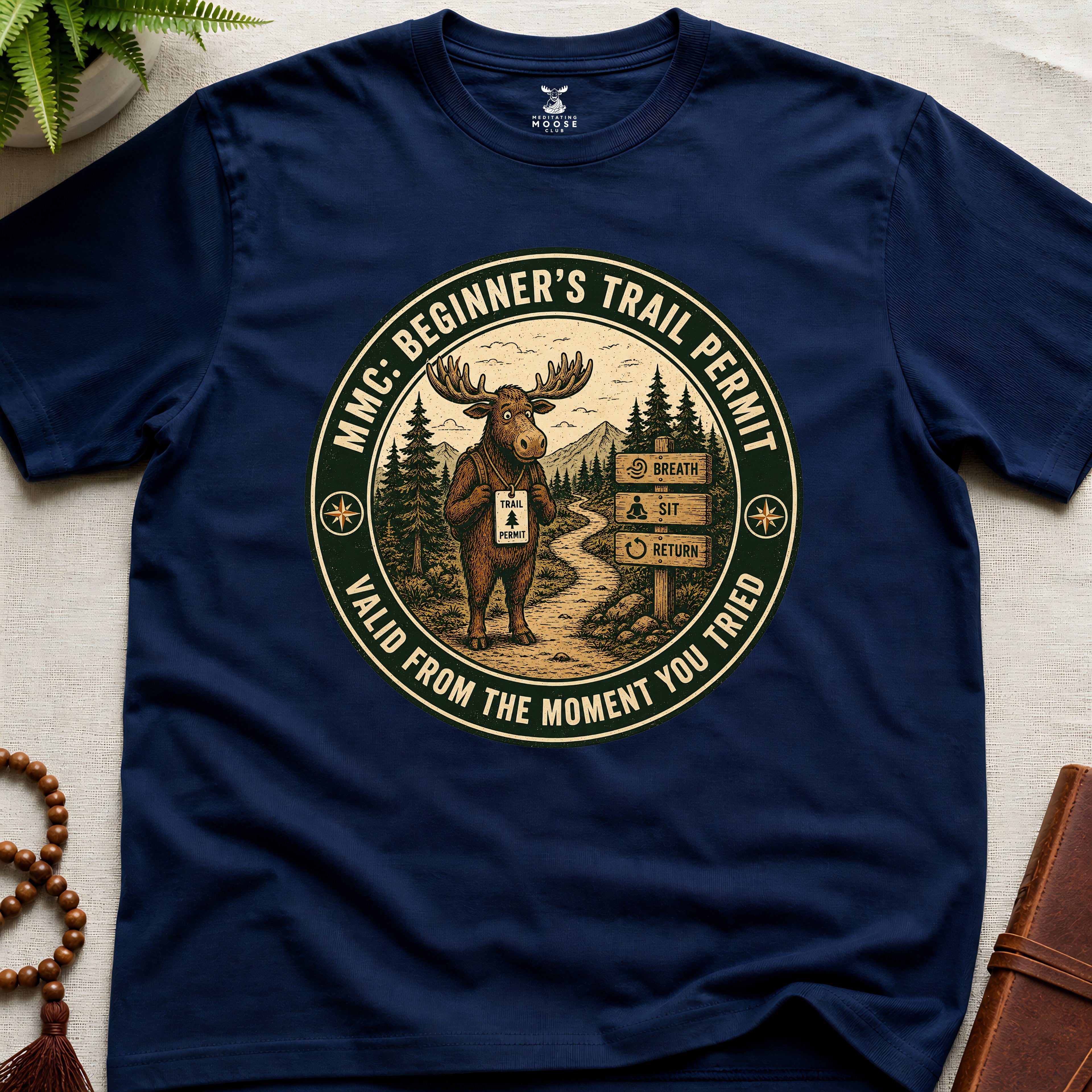 Navy mindfulness t-shirt mockup featuring Beginner’s Trail Permit meditating moose beginner meditation graphic