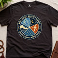 Dark brown t-shirt with a circular graphic design mental weather service on a light surface.