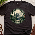 Dark brown t-shirt with a badge graphic design "Dept. of retroactive arguments" on a light surface.