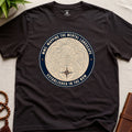 Dark brown mindfulness t-shirt with topographic landscape badge design featuring compass