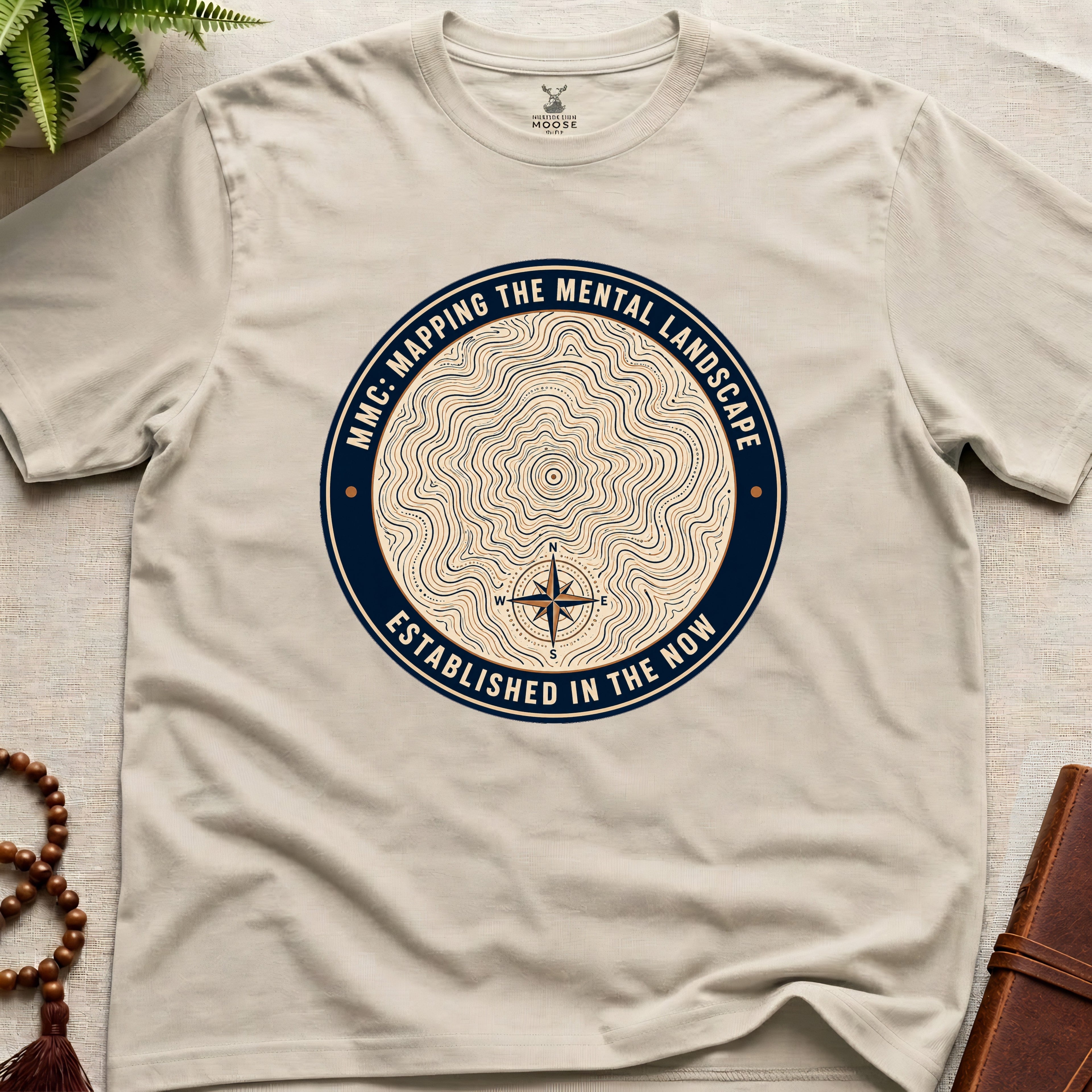 Natural mindfulness t-shirt with topographic landscape badge design featuring compass
