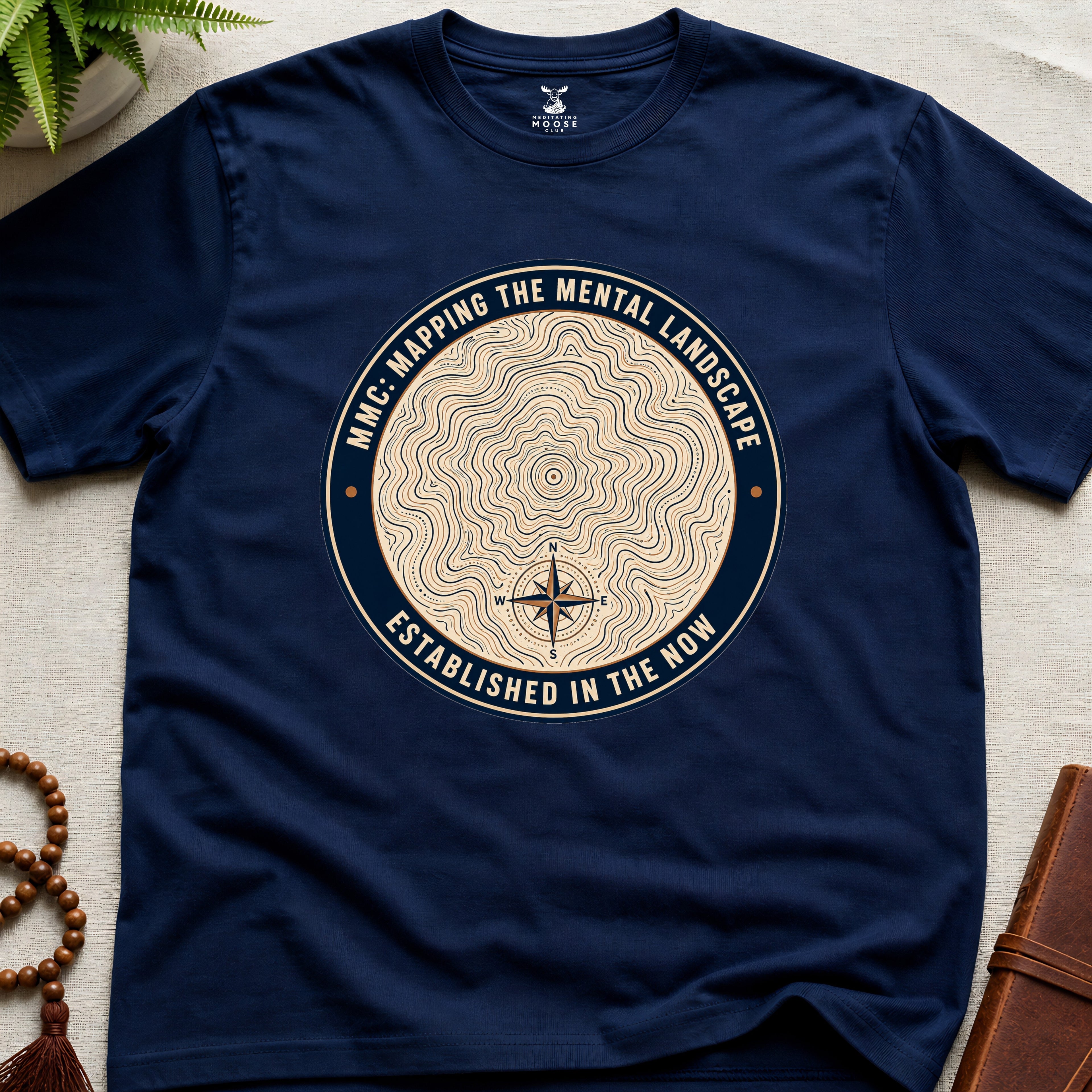 Navy mindfulness t-shirt with topographic landscape badge design featuring compass
