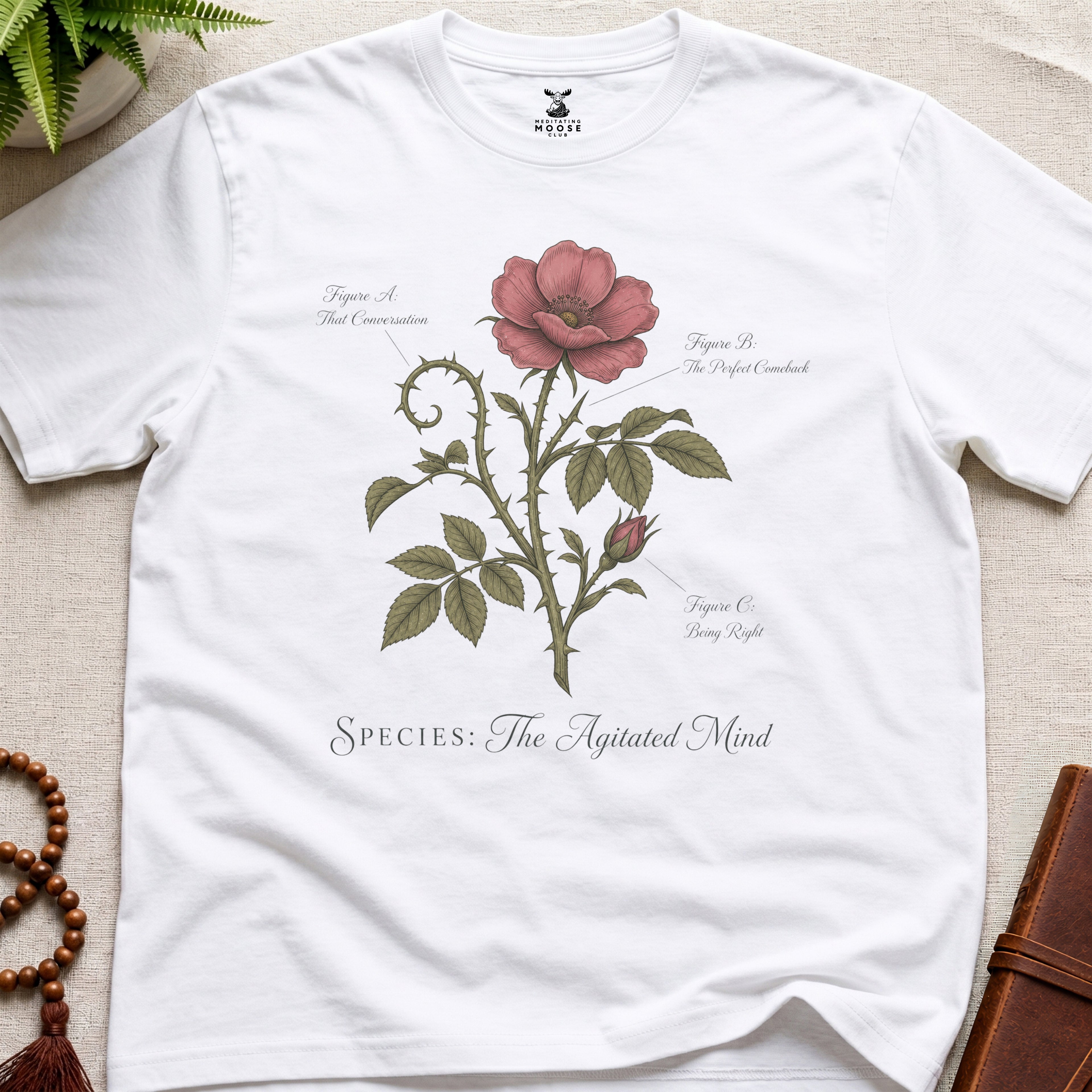 White vintage botanical graphic t-shirt featuring agitated mind natural history illustration