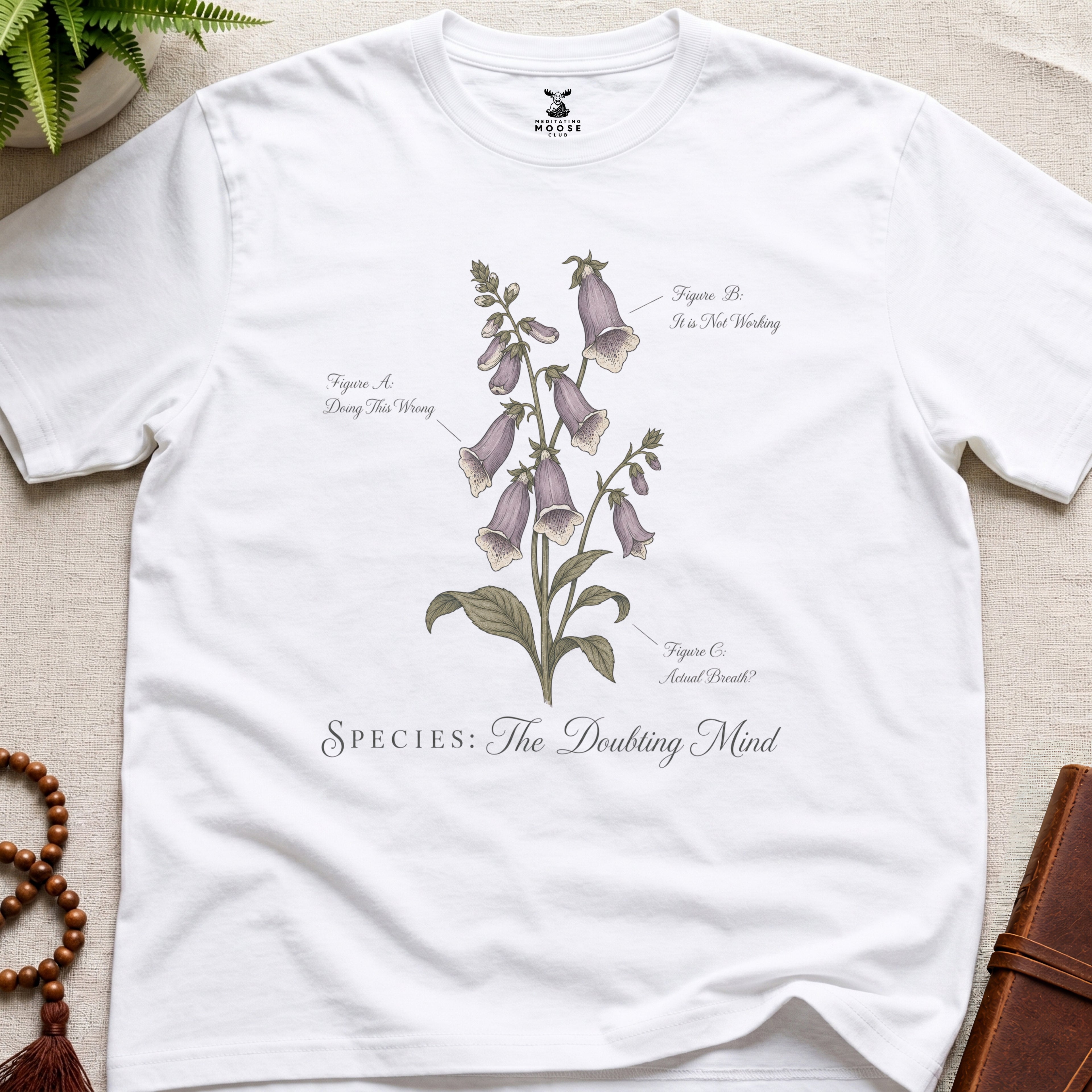 White vintage botanical graphic t-shirt featuring doubting mind natural history illustration