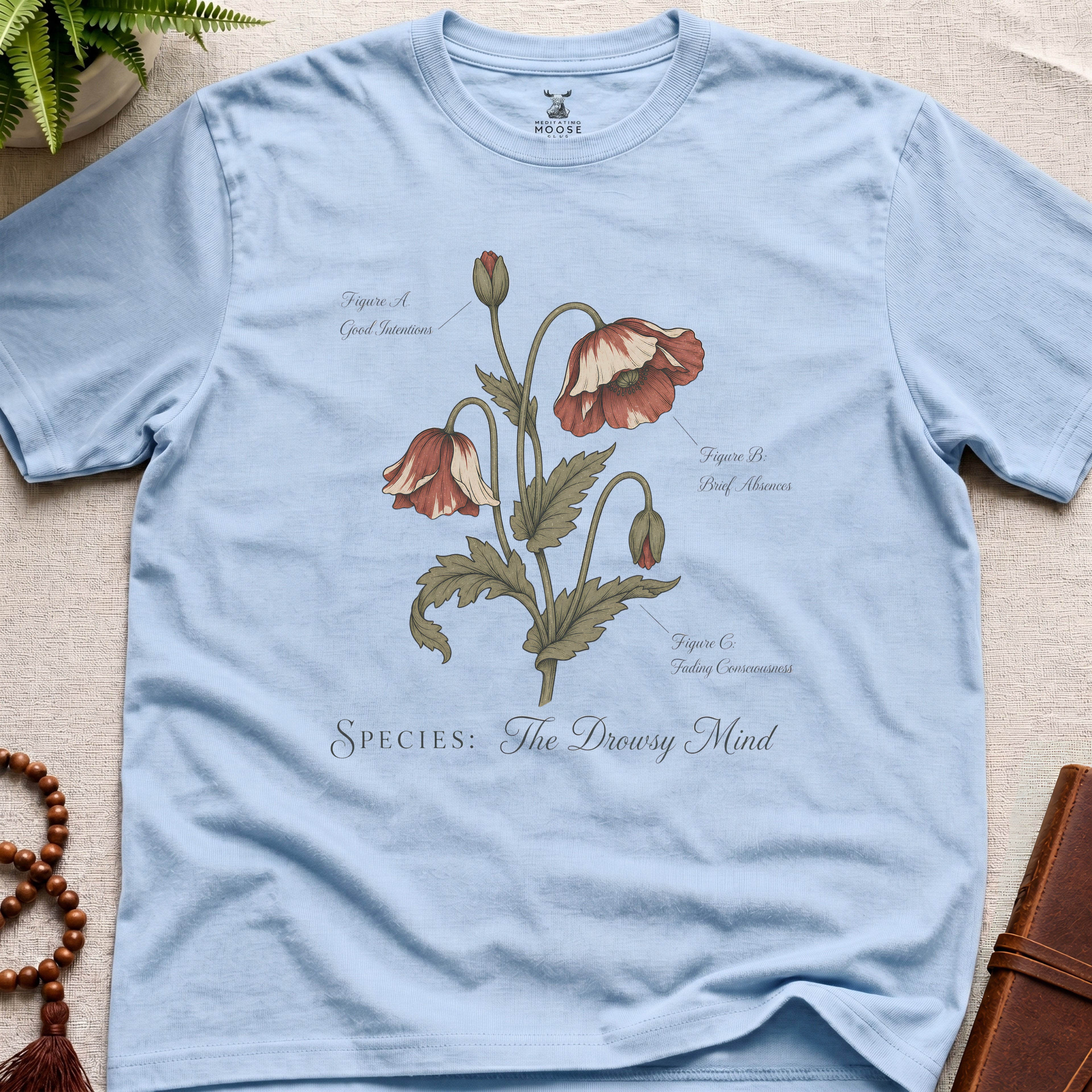 Light blue vintage botanical graphic t-shirt featuring drowsy mind natural history illustration