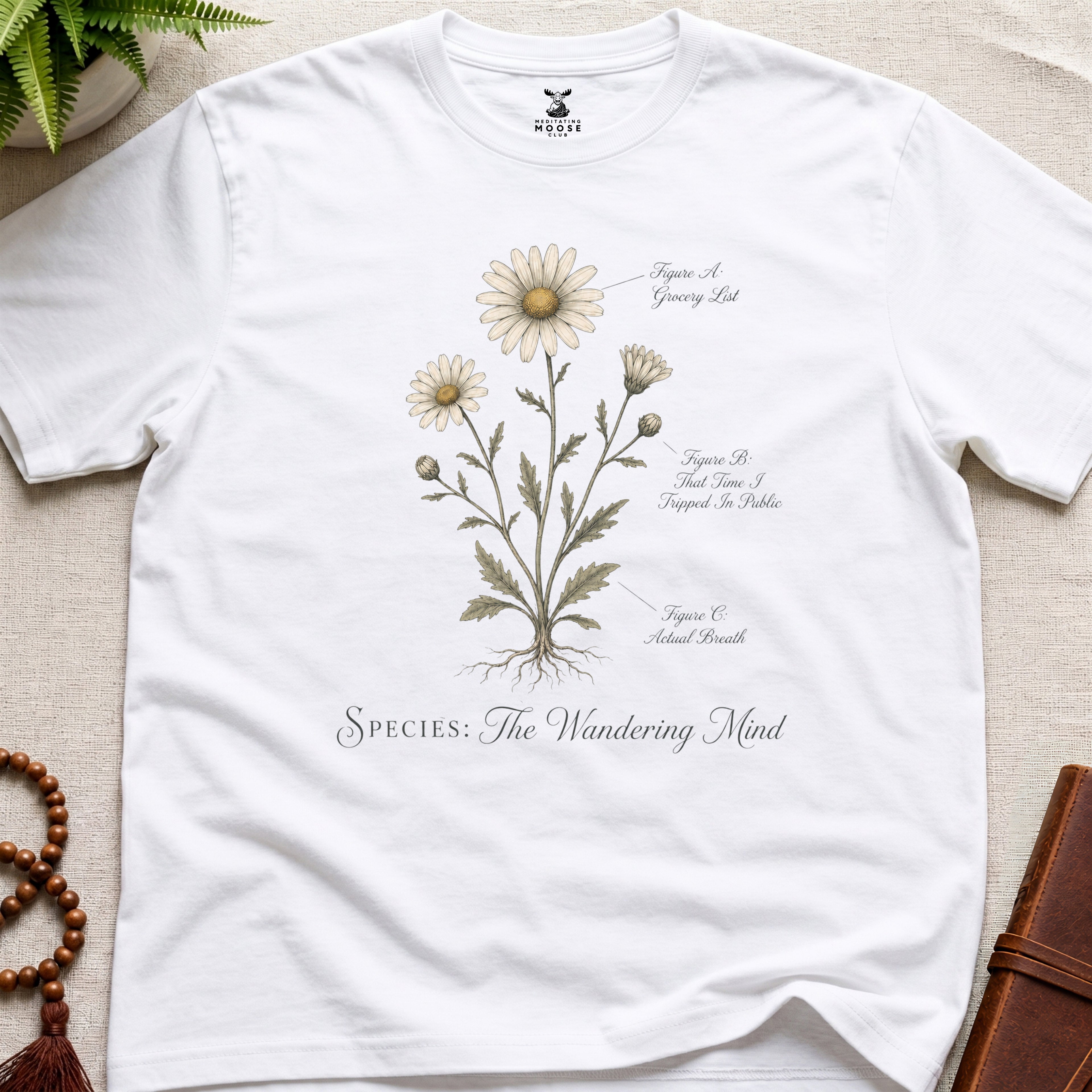 White vintage botanical graphic t-shirt featuring wandering mind natural history illustration