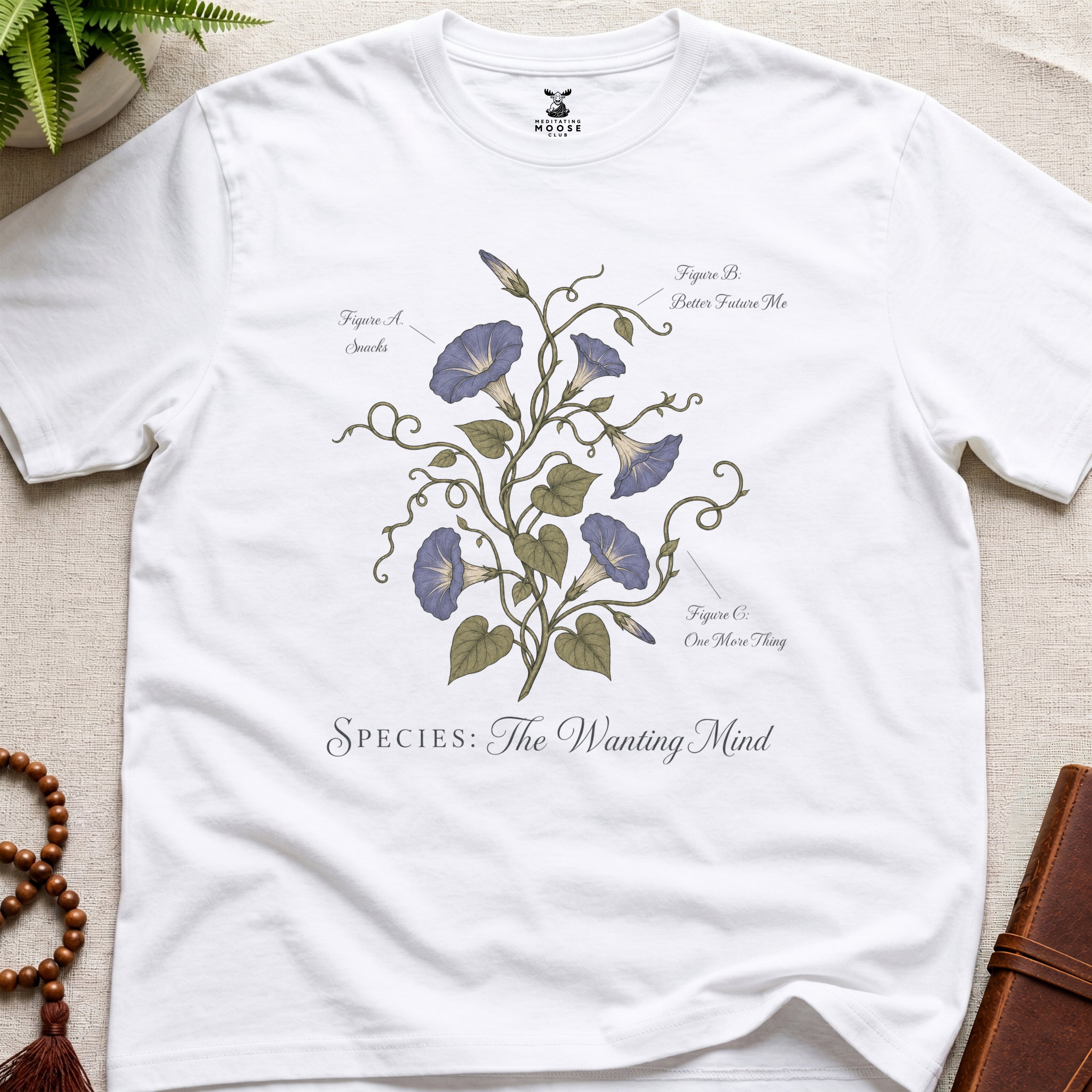 White t-shirt with floral design and text on a beige surface
