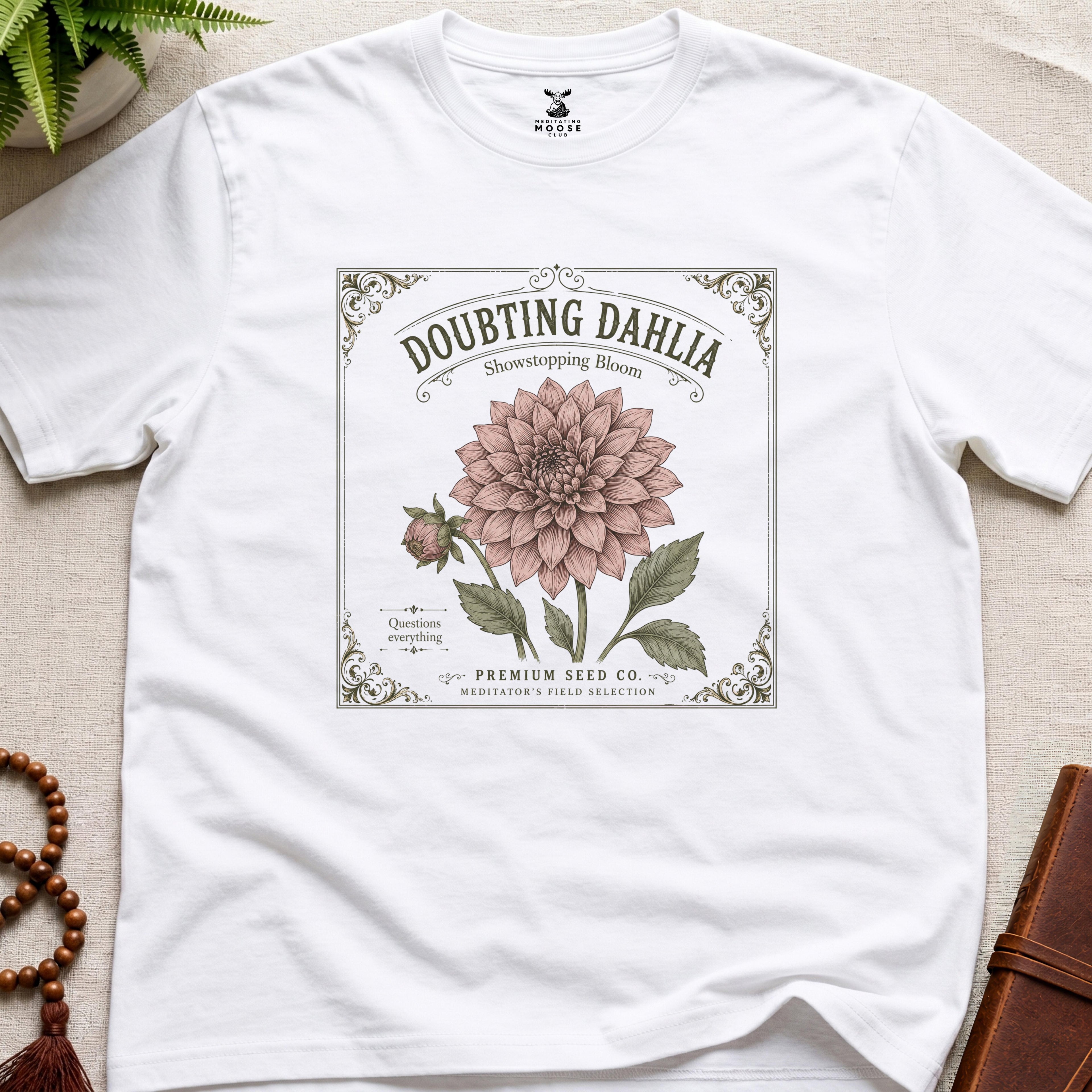 White t-shirt with a vintage seed packet style flower graphic doubting dahlia showstopping bloom