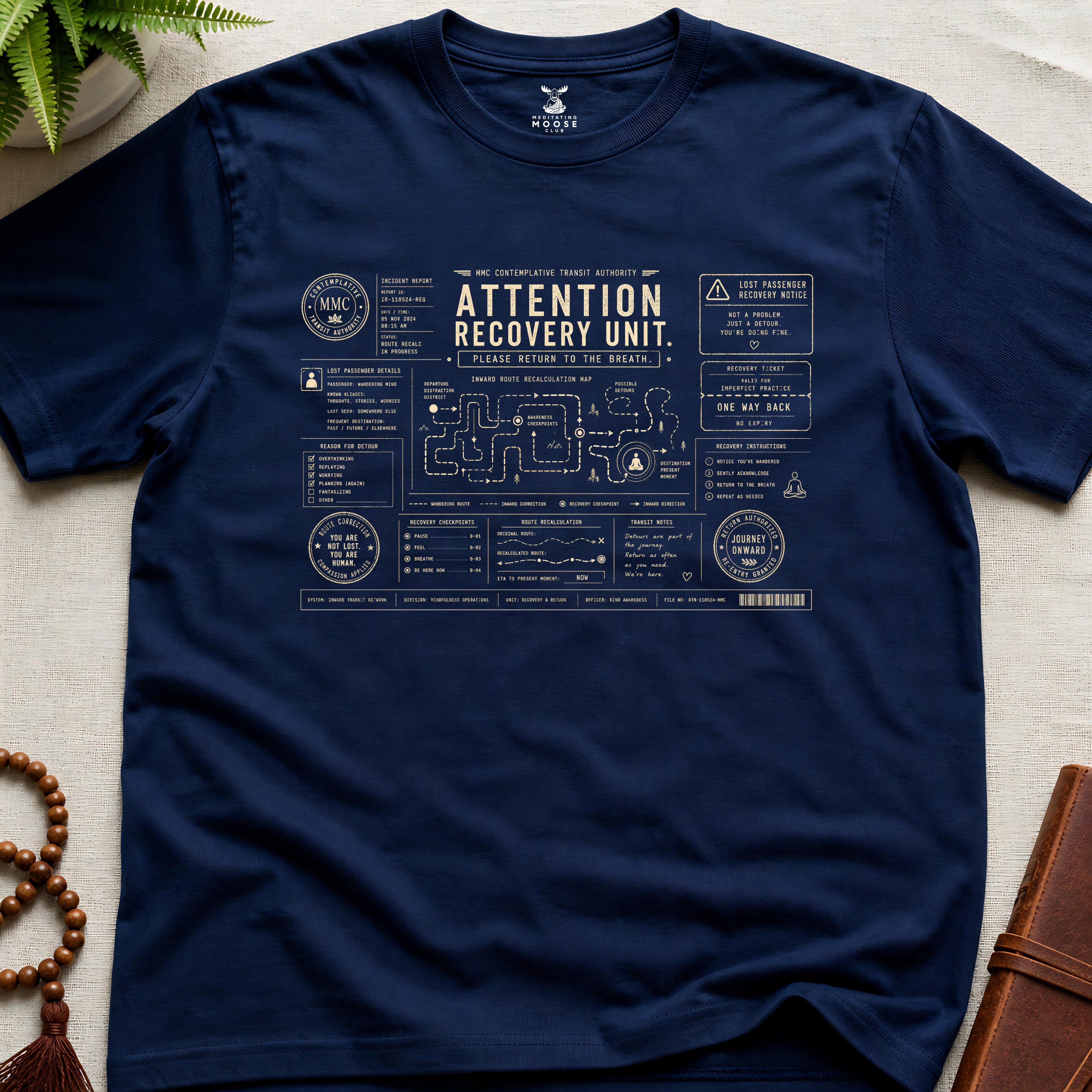 Navy mindfulness transit recovery t-shirt graphic reading “Attention Recovery Unit” with inward rerouting diagrams and contemplative navigation systems.