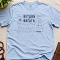 Light blue contemplative navigation-chart t-shirt graphic reading “Return To Breath” with compass systems and inward route diagrams.