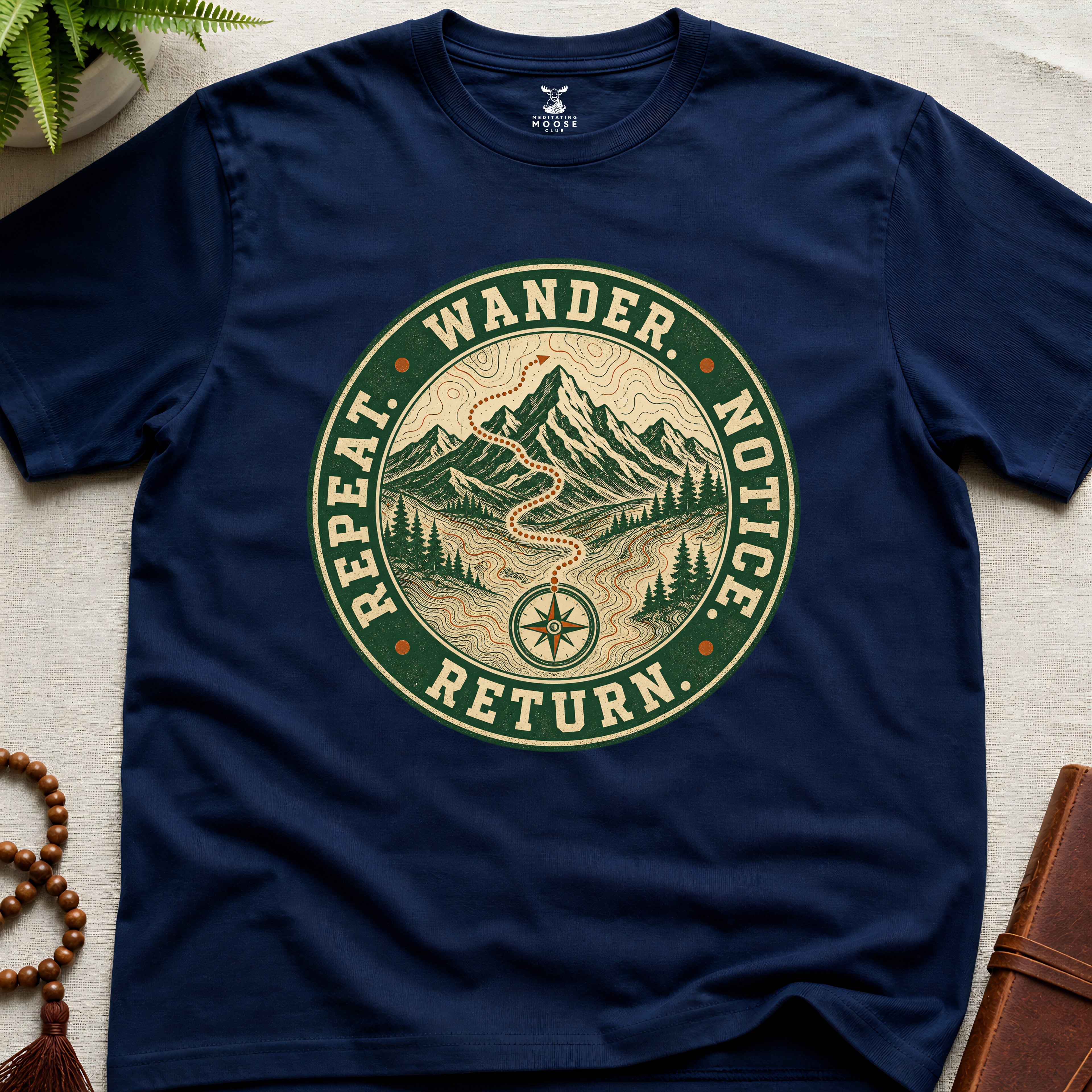 Navy mindfulness t-shirt mockup featuring Wander Notice Return vintage mountain meditation badge graphic