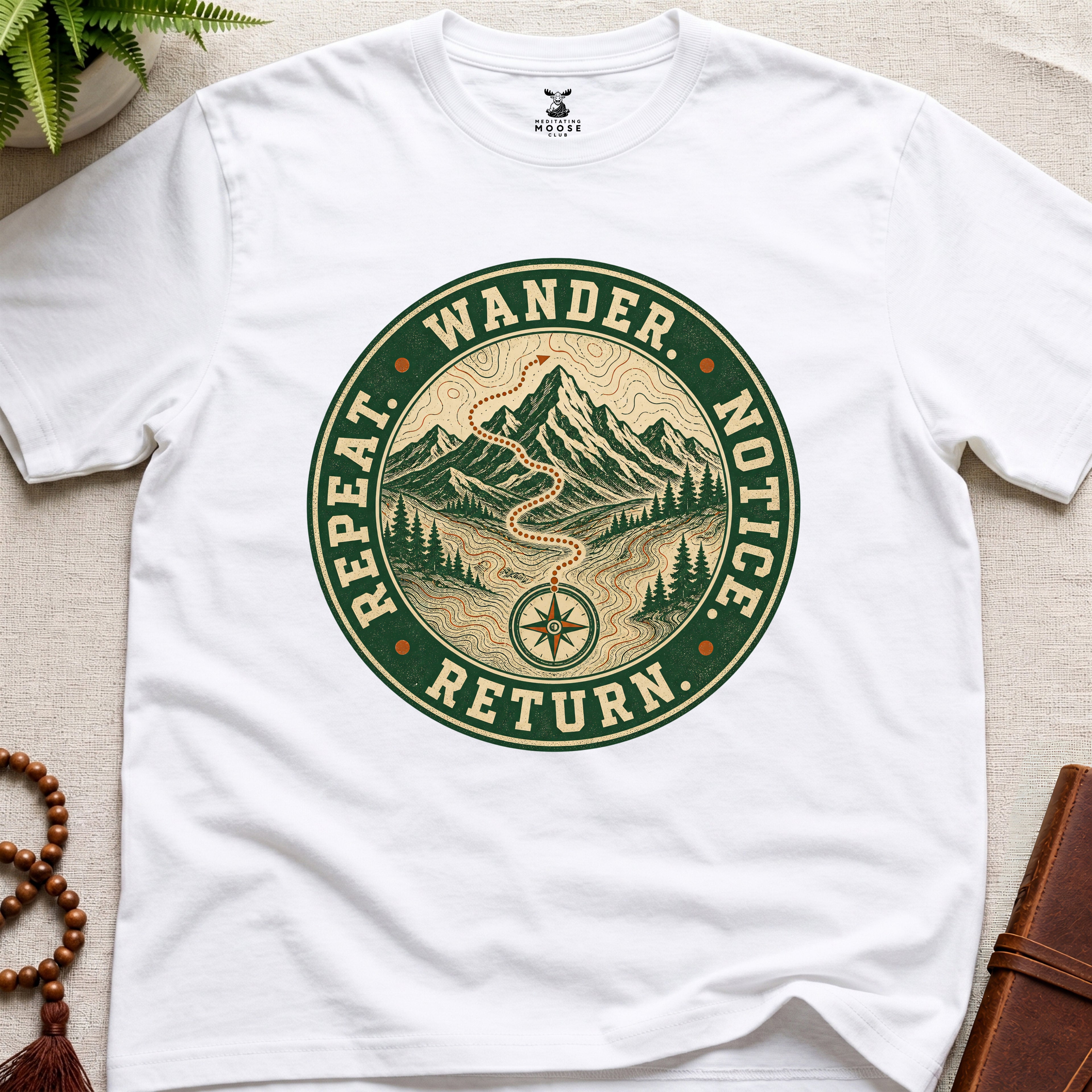 White mindfulness t-shirt mockup featuring Wander Notice Return vintage mountain meditation badge graphic