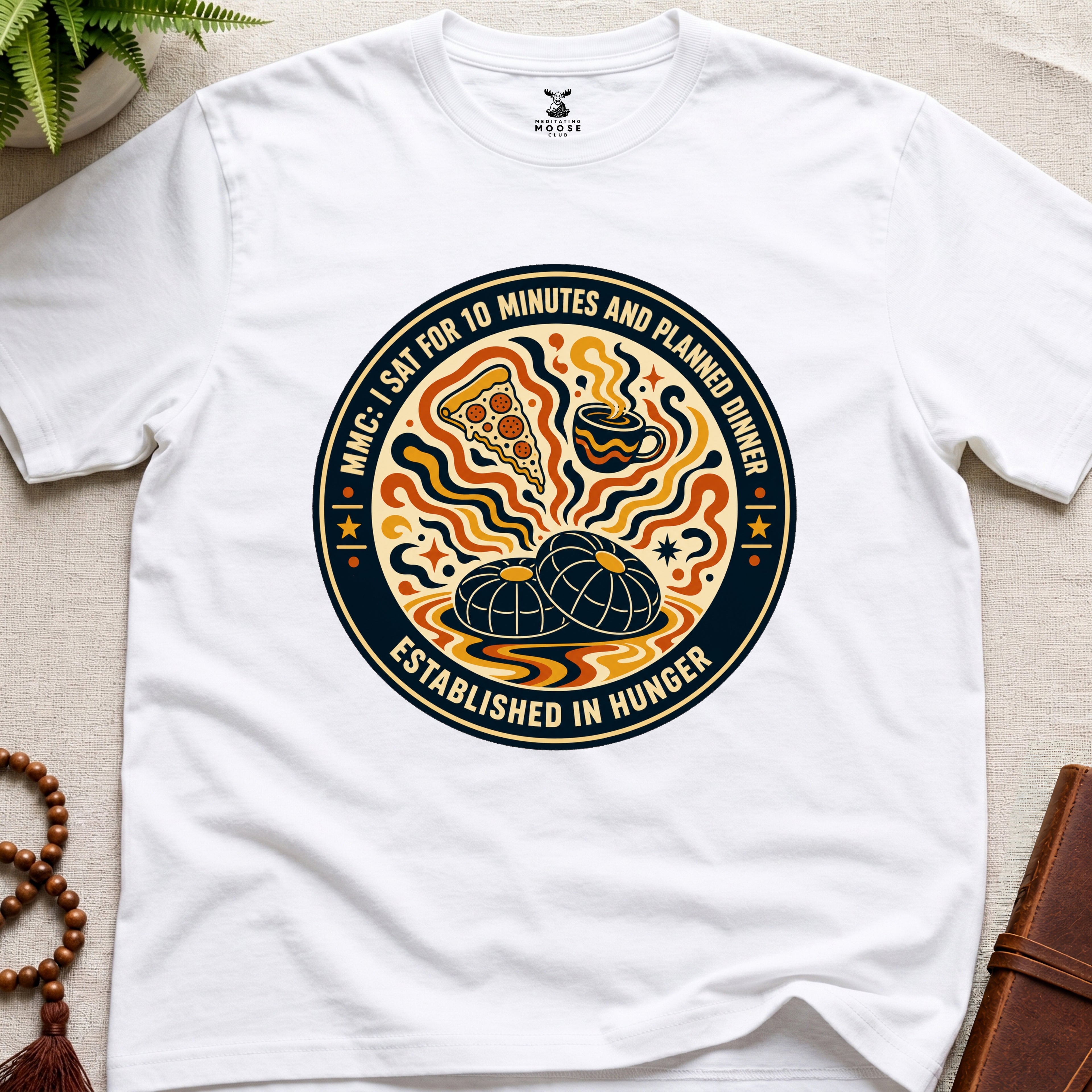 A funny white meditation t-shirt with retro hunger badge design featuring pizza coffee and mindfulness humour